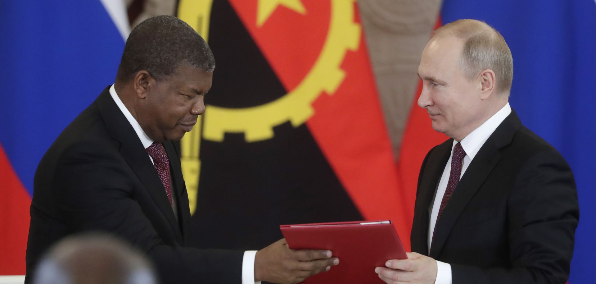 Angolan President Joao Lourenco, left, and Russian President Vladimir Putin exchange documents during a signing ceremony in Moscow on April 4, 2019.