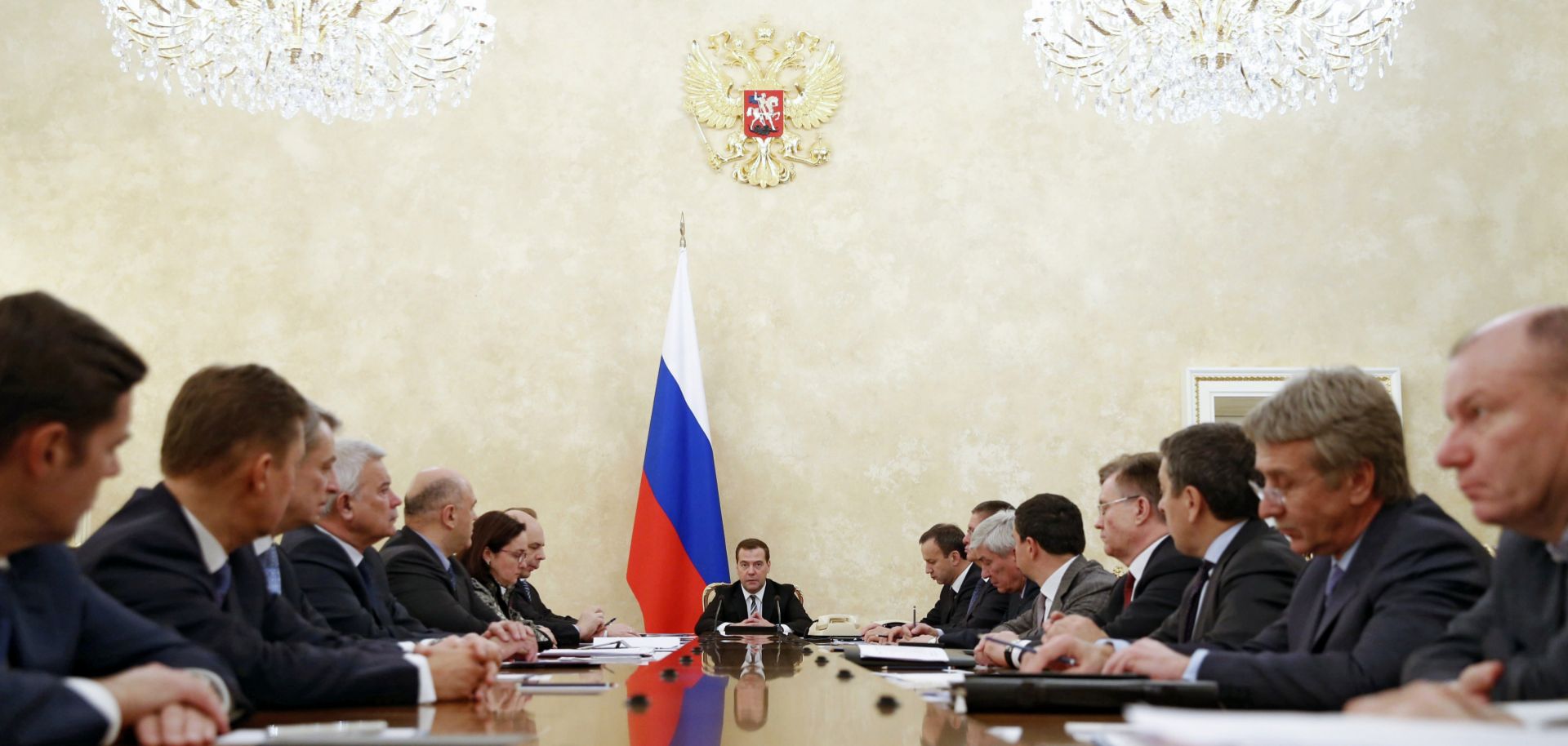 Russian Prime Minister Dmitri Medvedev (C) meets with members of the government's finance and economy ministries in 2014 to discuss policy