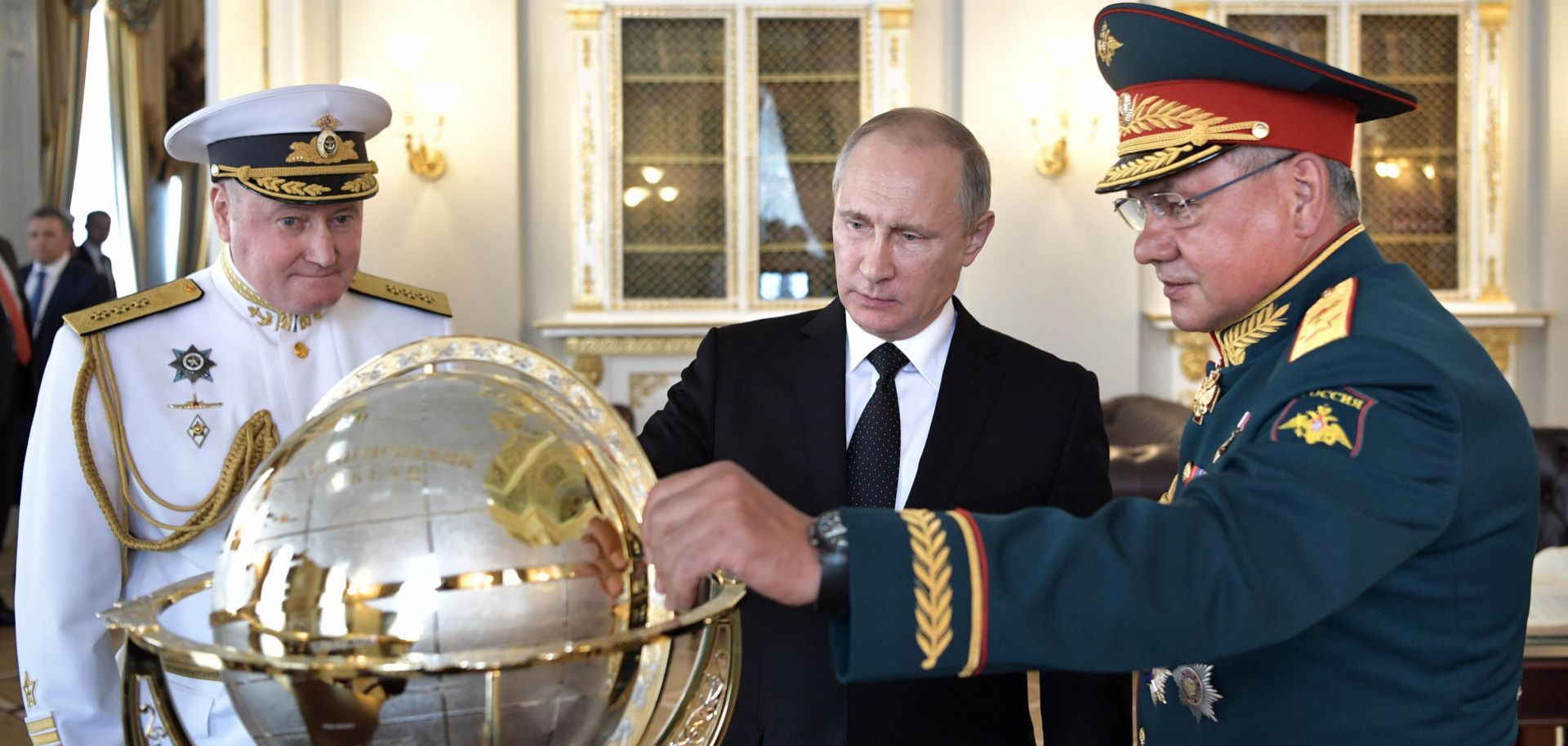 Russian President Vladimir Putin (C) and Defense Minister Sergei Shoigu visit the headquarters of the Russian navy in 2017.