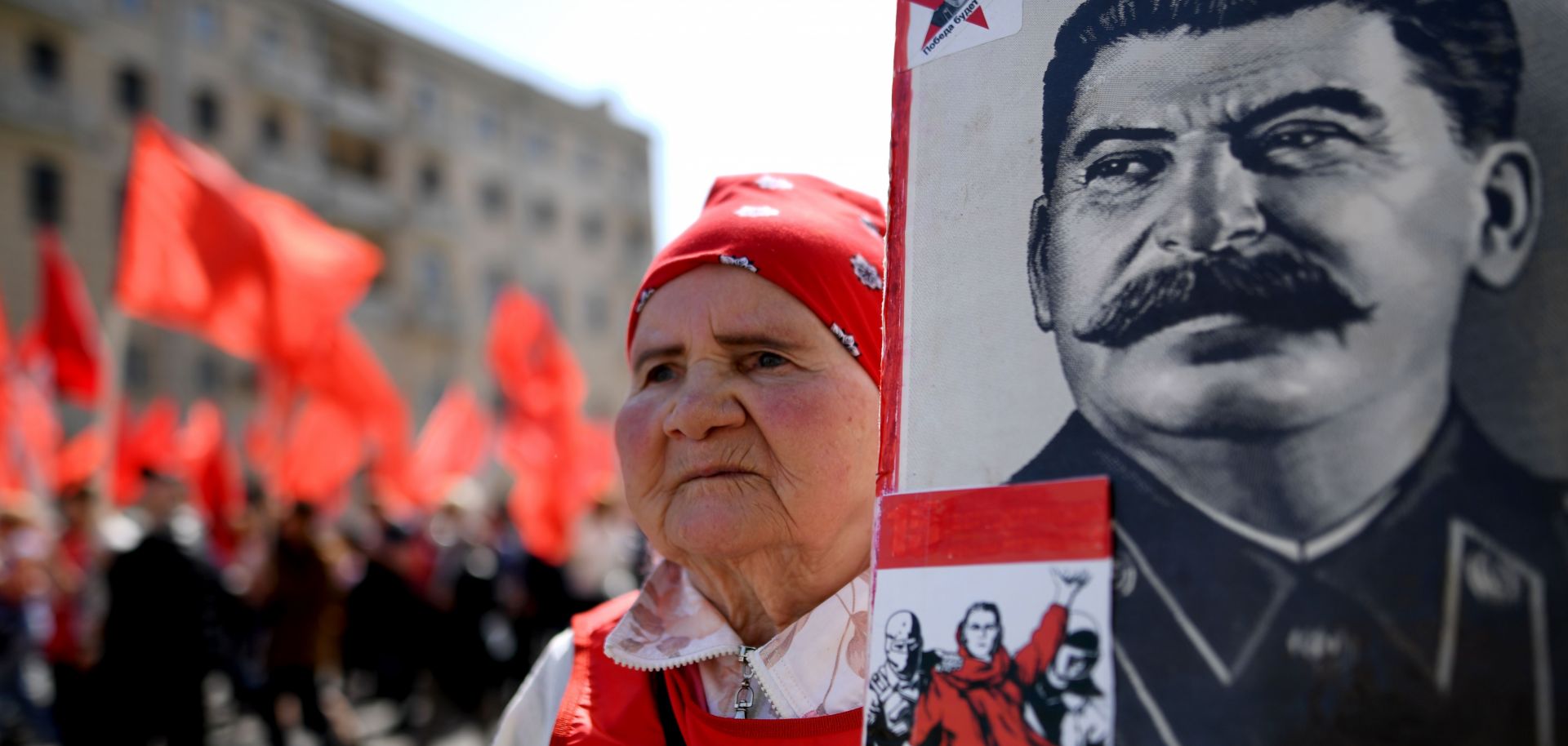 A supporter of Russia's Communist Party brandishes a poster bearing infamous Soviet leader Josef Stalin's likeness during a May Day celebration.