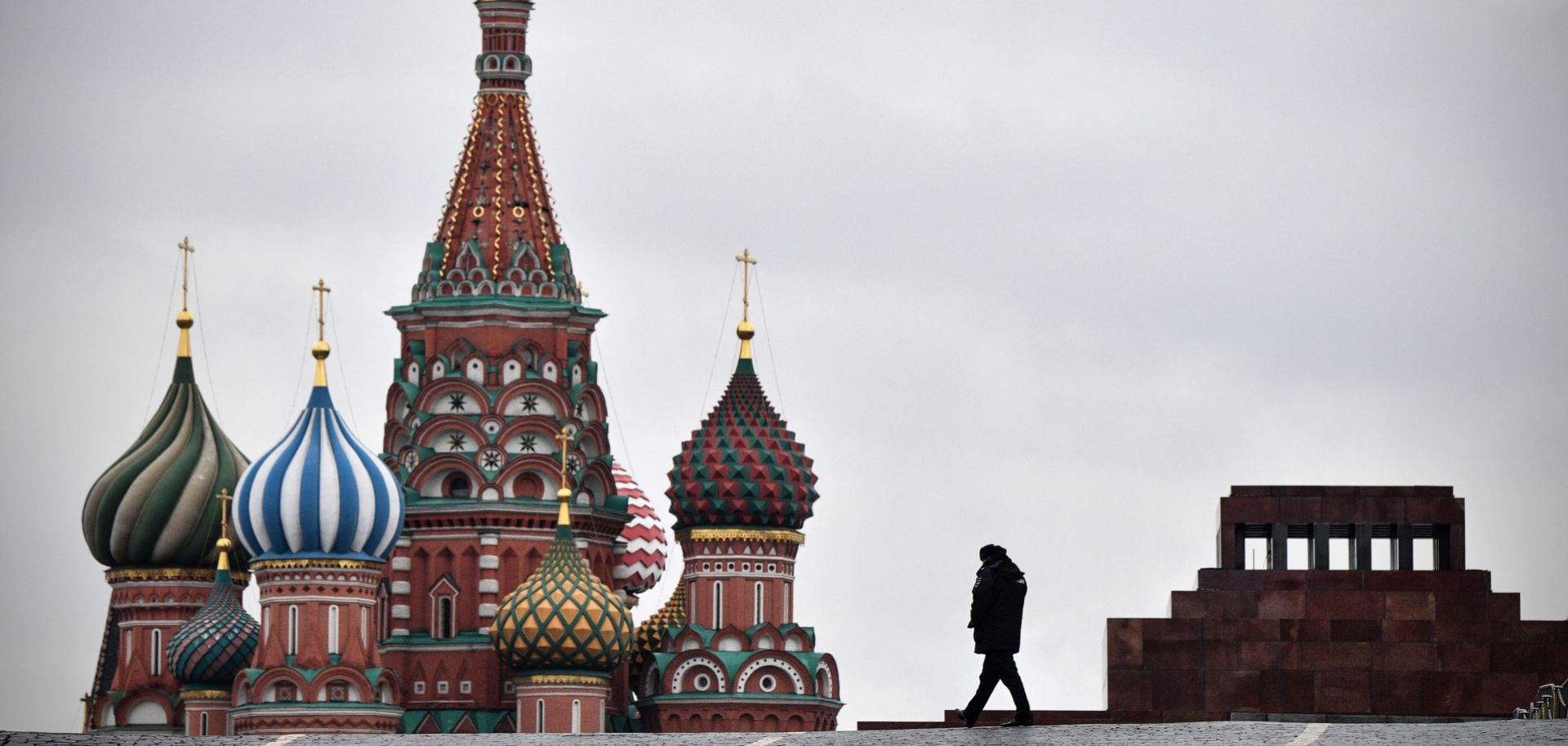 A Russian policeman walks in Red Square in Moscow on Nov. 5, 2017, with the Lenin Mausoleum and St. Basil's Cathedral in the background.