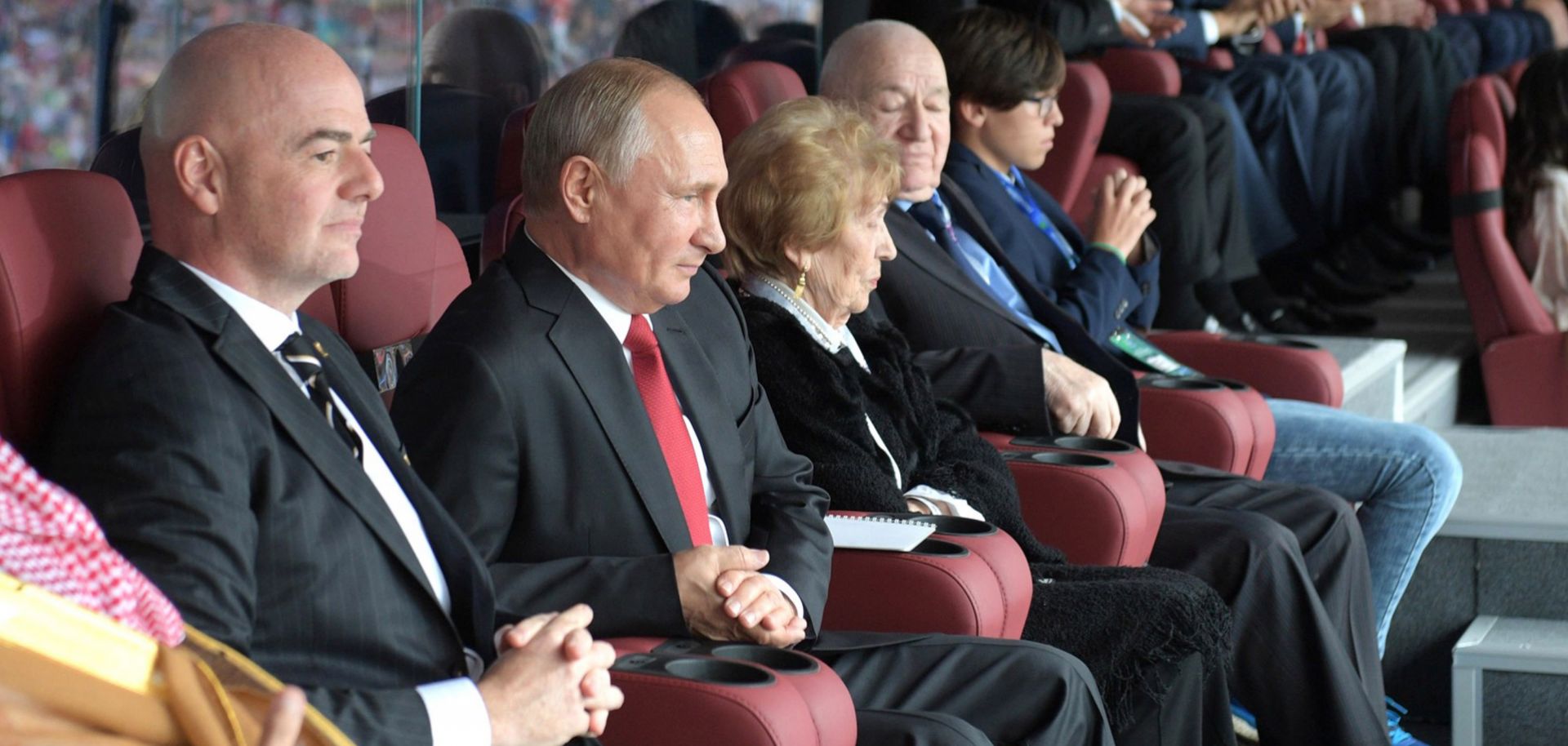 Russian President Vladimir Putin (C) watches the opening game of the 2018 World Cup next to FIFA President Gianni Infantino (L), who has praised him for the turnout at the tournament.