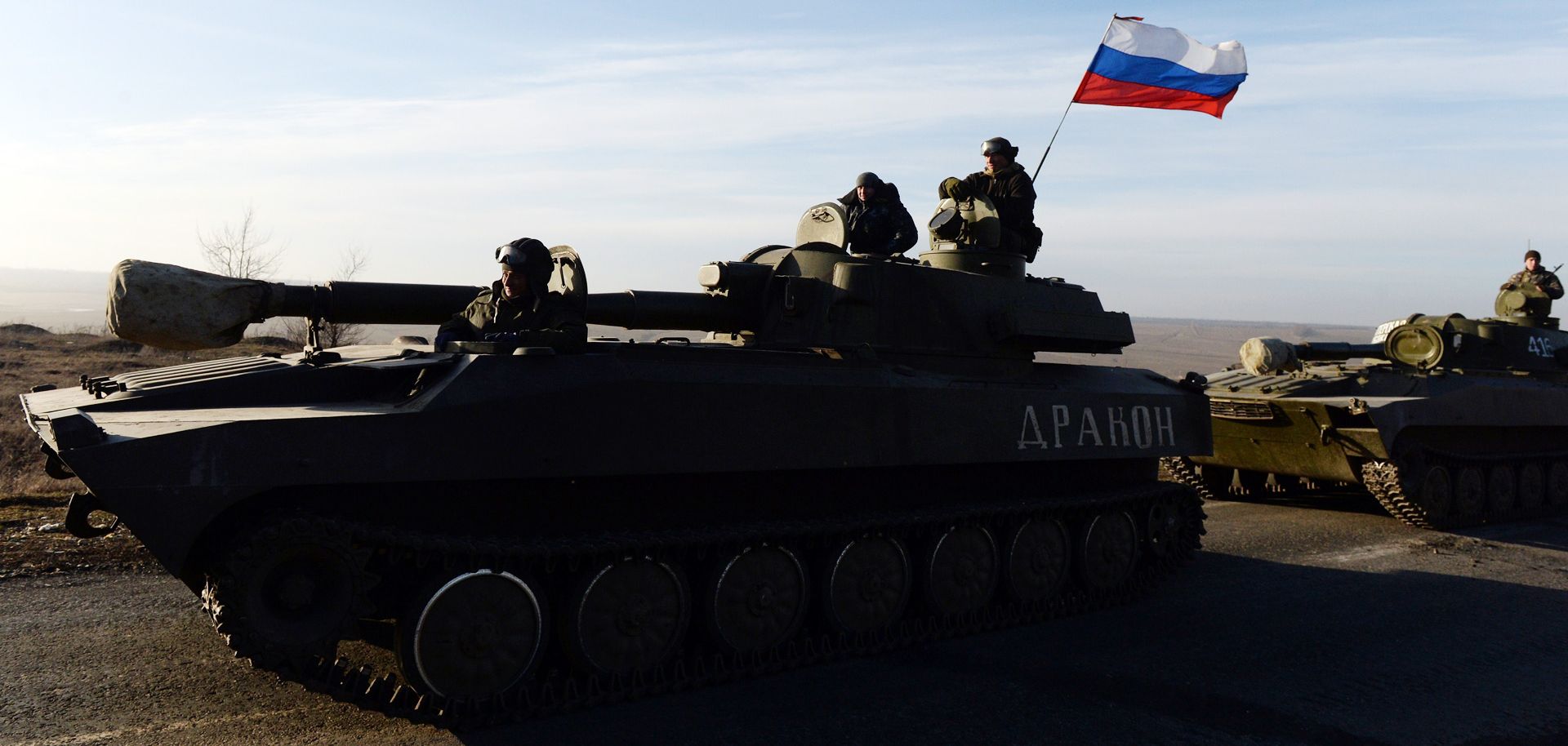 A picture of a Russian self-propelled artillery gun motoring along a Ukrainian highway