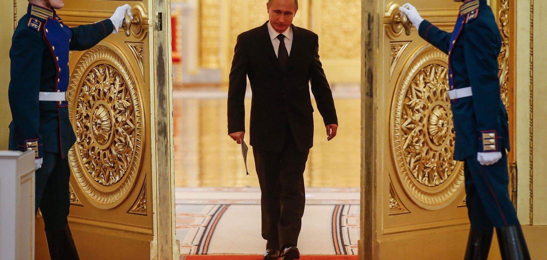 Russian President Vladimir Putin enters a hall.