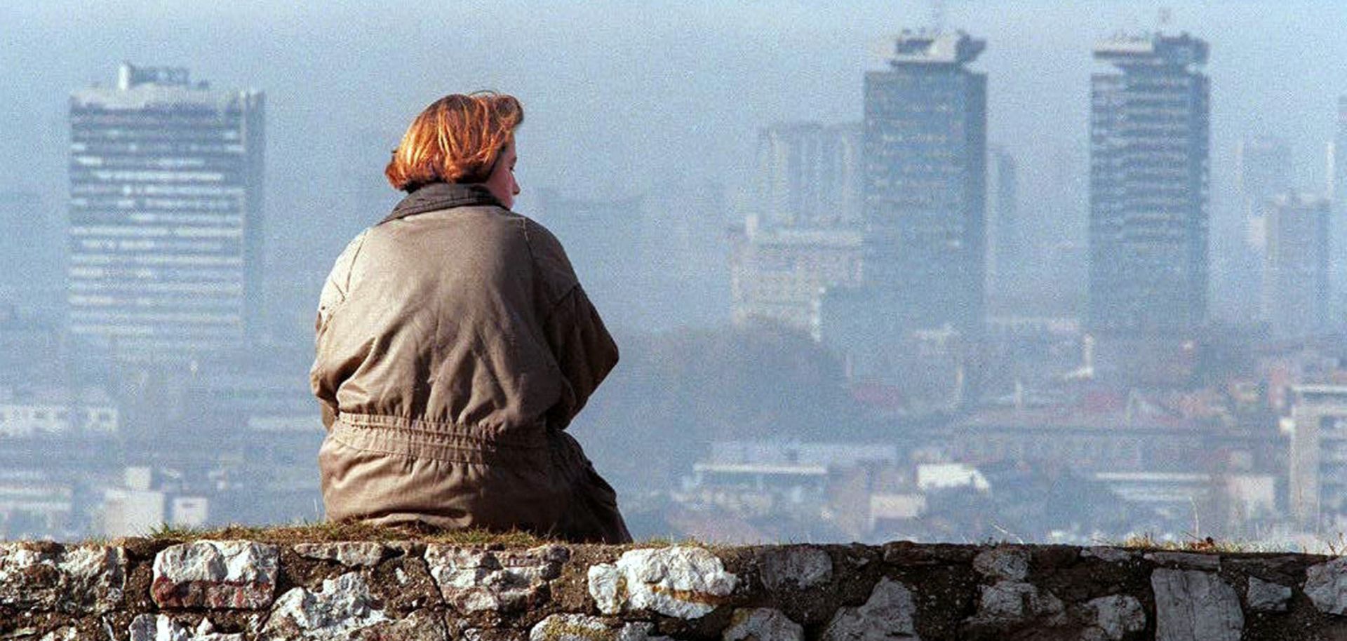 A Bosnia woman takes in the Sarajevo skyline from a location shielded from snipers, Nov. 17, 1995.