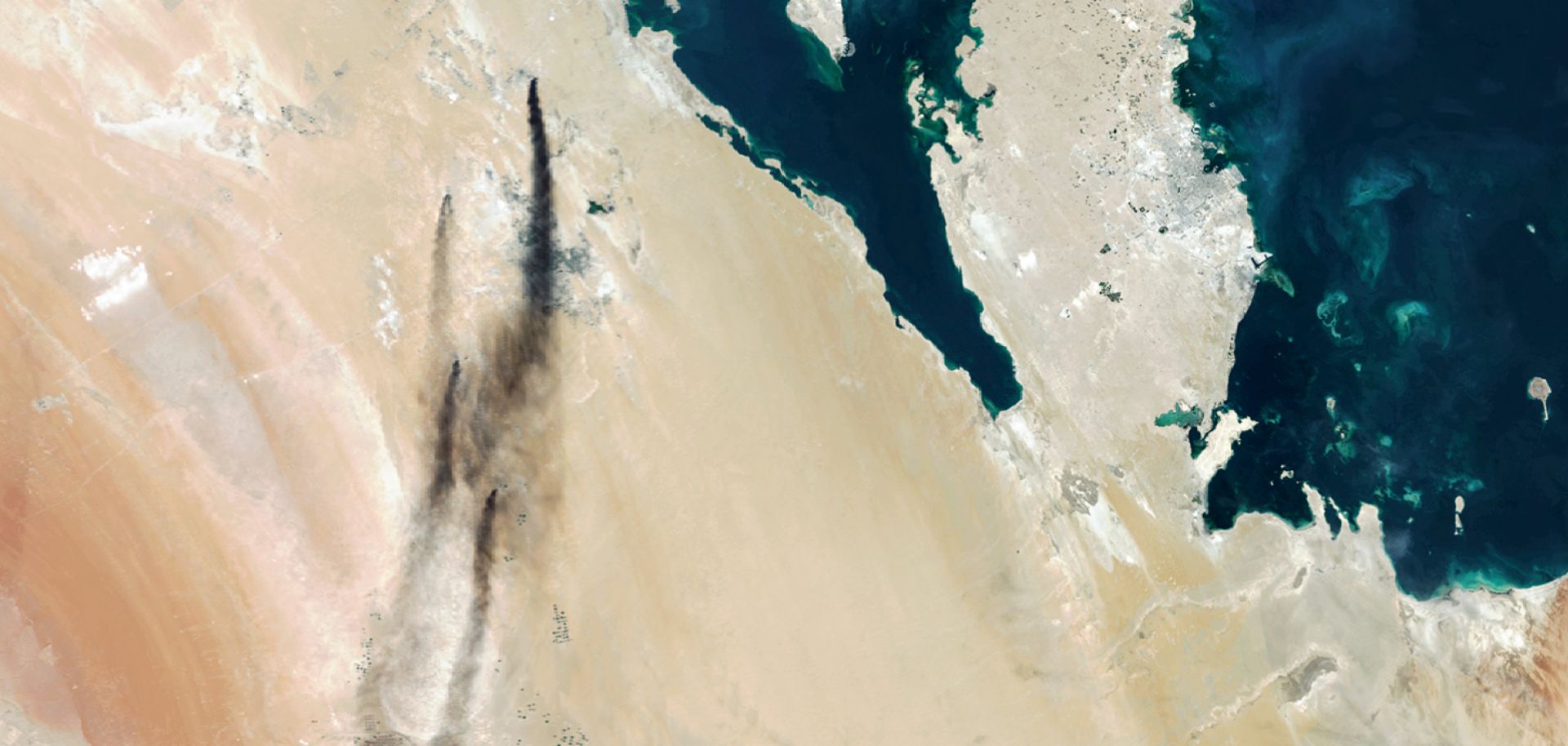 This satellite photo shows smoke pouring from two Saudi oil production facilities hit in Sept. 14 attacks.