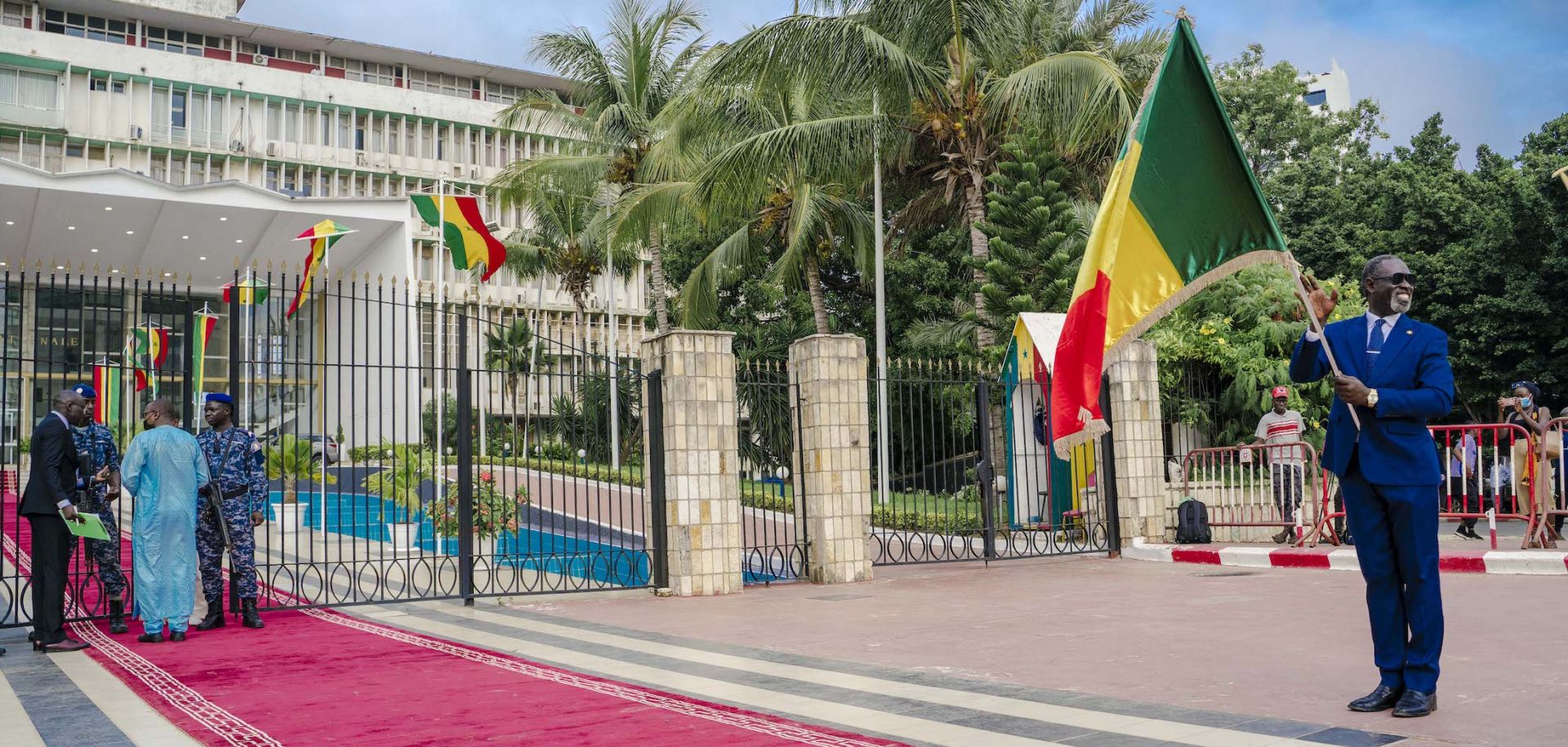 A man holds a Senegalese flag in front of the Parliament in Dakar on Sept. 12, 2022, ahead of the first parliamentary session since the July 2022 legislative elections.