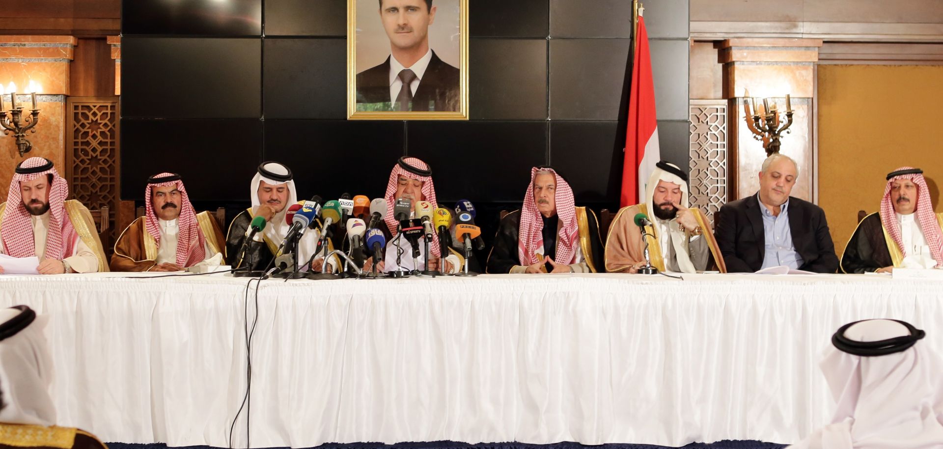 Members of Syria's pro-government tribes sit for a press conference.