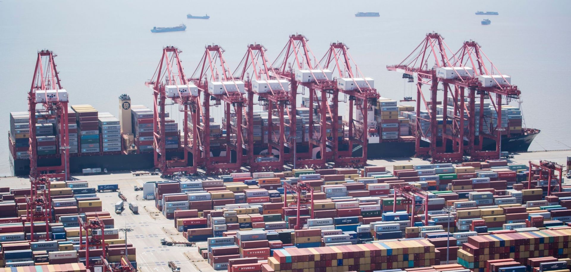 A picture shows a sprawling docklands stacked with shipping containers.