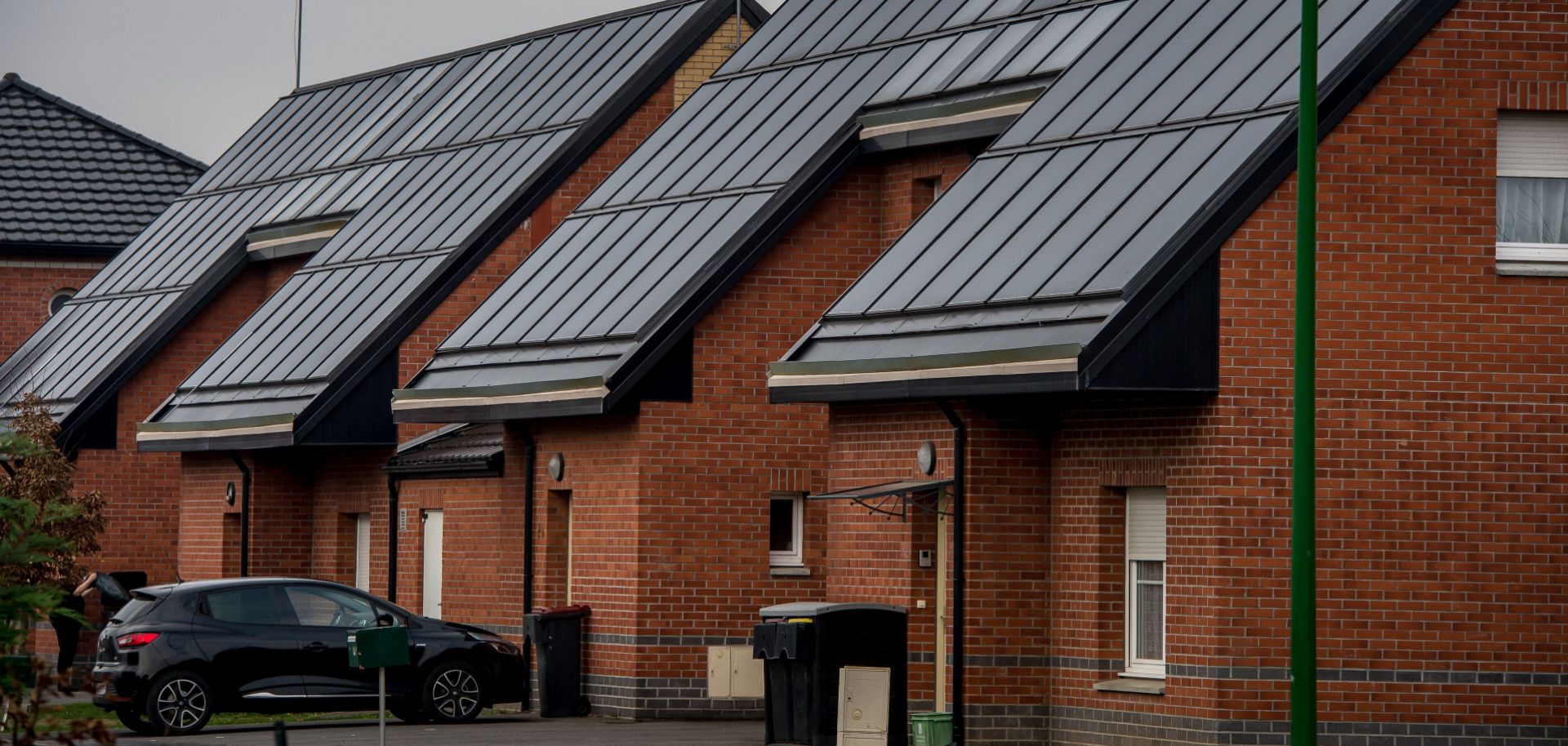 Solar panels power a pair of brick houses in Loos-en-Gohelle, France.