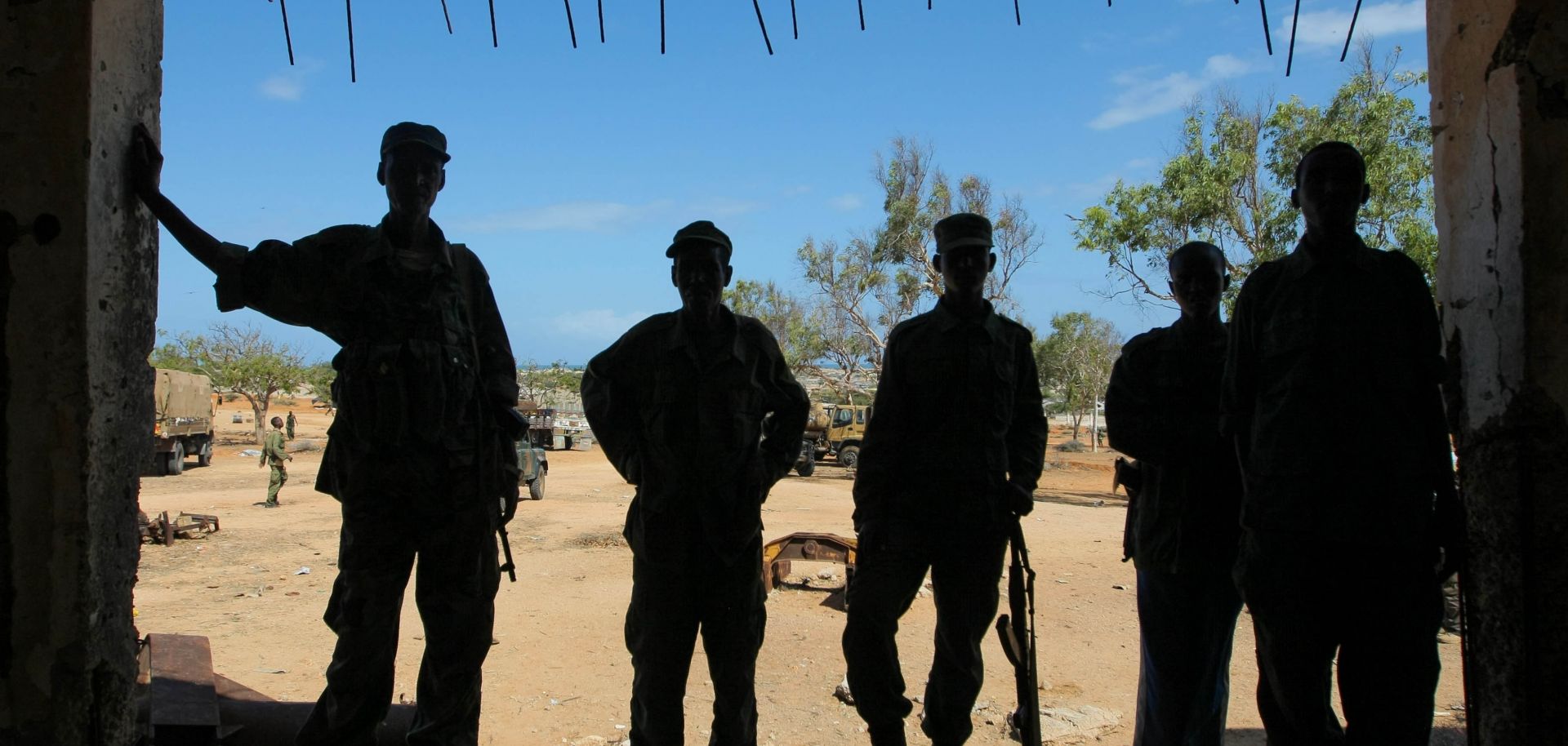 Soldiers stand in the entrance of a former police station.