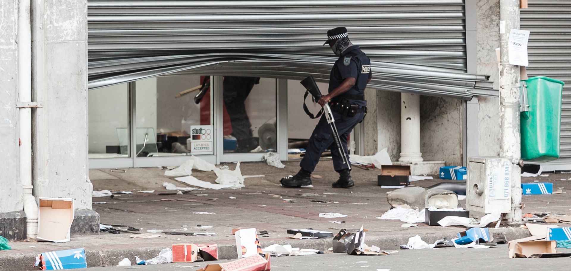 A police officer scans a looted retail store in central Durban, South Africa, on July 11, 2021. 
