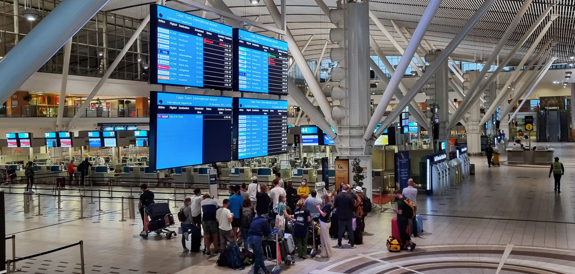 Passengers wait to check in for one of the last international flights out of Cape Town, South Africa, after countries began imposing travel bans to contain the spread of the new Omicron COVID-19 variant on Nov. 29, 2021. 
