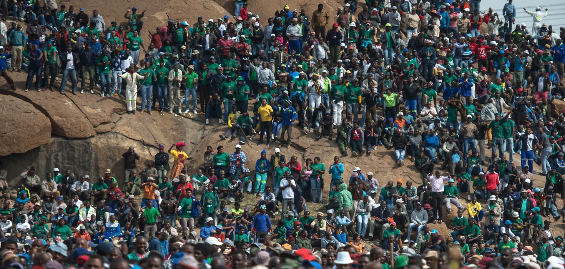 Miners gather for a rally on the anniversary of an incident in which 34 miners were killed by police during a strike