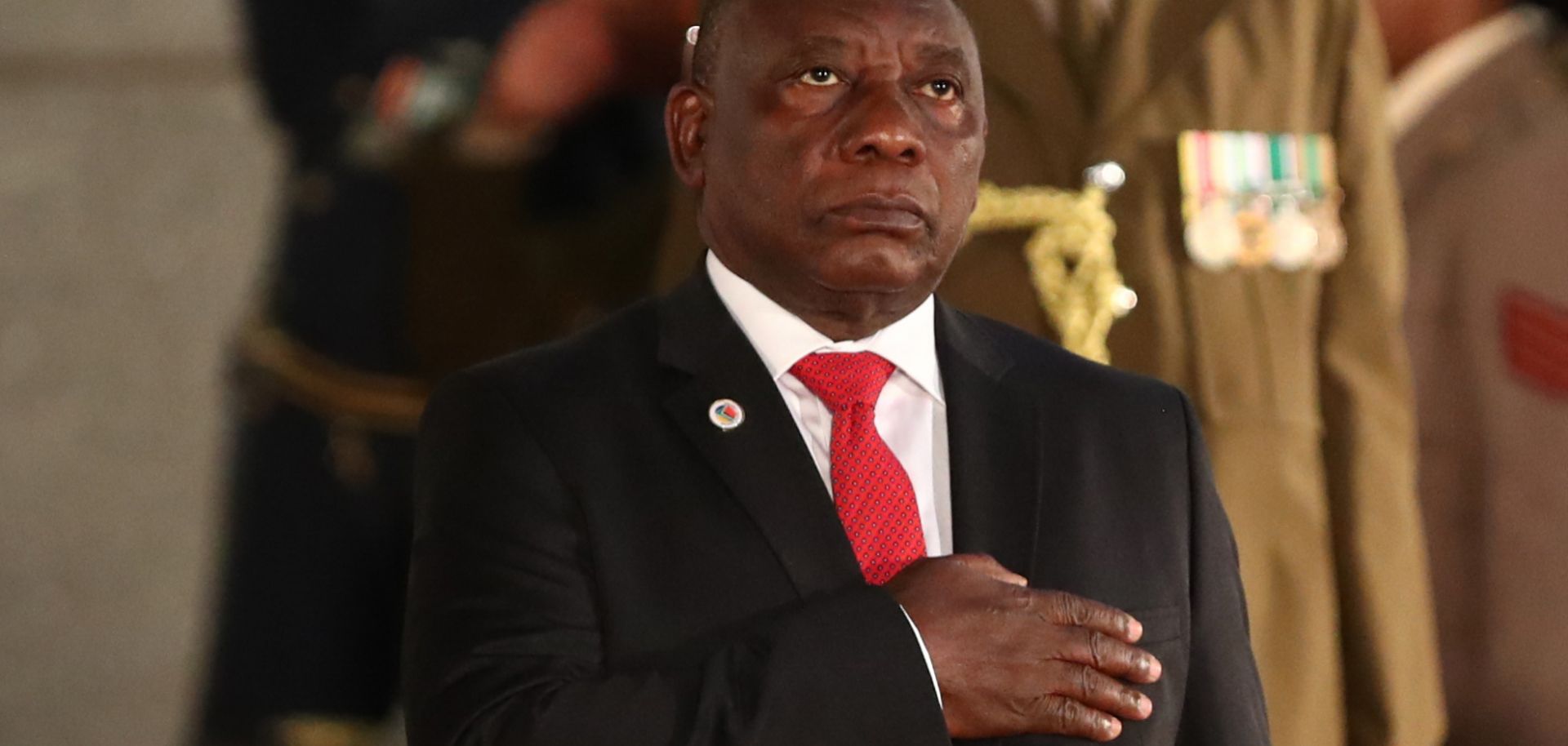 South African President Cyril Ramaphosa stands during the national anthem before delivering his annual State of the Nation address to parliament in Cape Town on June 20, 2019.