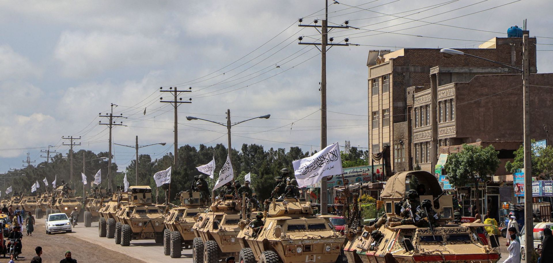 Taliban fighters in armoured vehicles in a military street parade in Herat. 