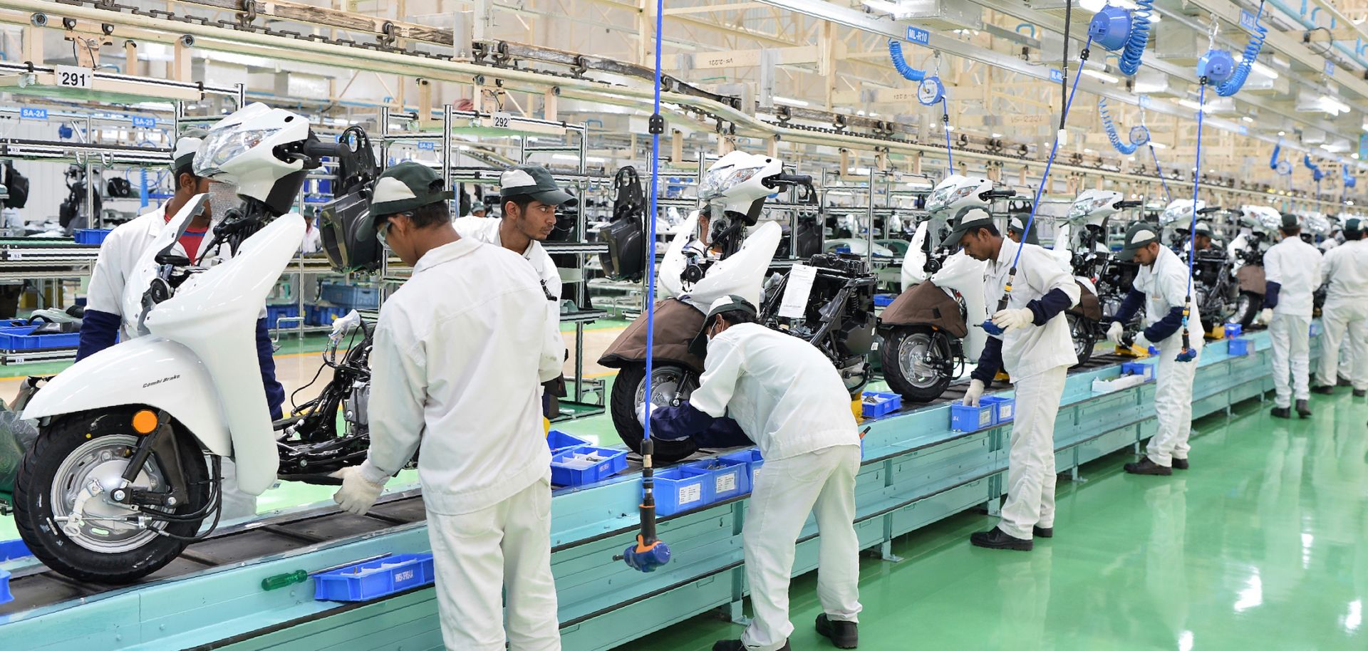 Employees assemble parts and make final inspections of Honda Activa scooters in Narasapura, on the outskirts of Bangalore, India. 