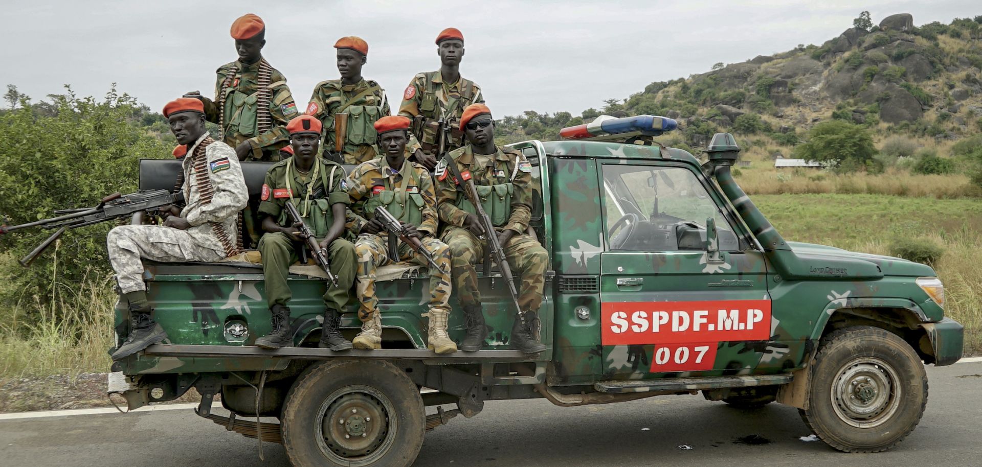 South Sudanese military police officers sit on a pickup truck as they monitor the area during a deployment ceremony for South Sudan's unified forces at the Luri Military Training Center in Juba on Nov. 15, 2023. 