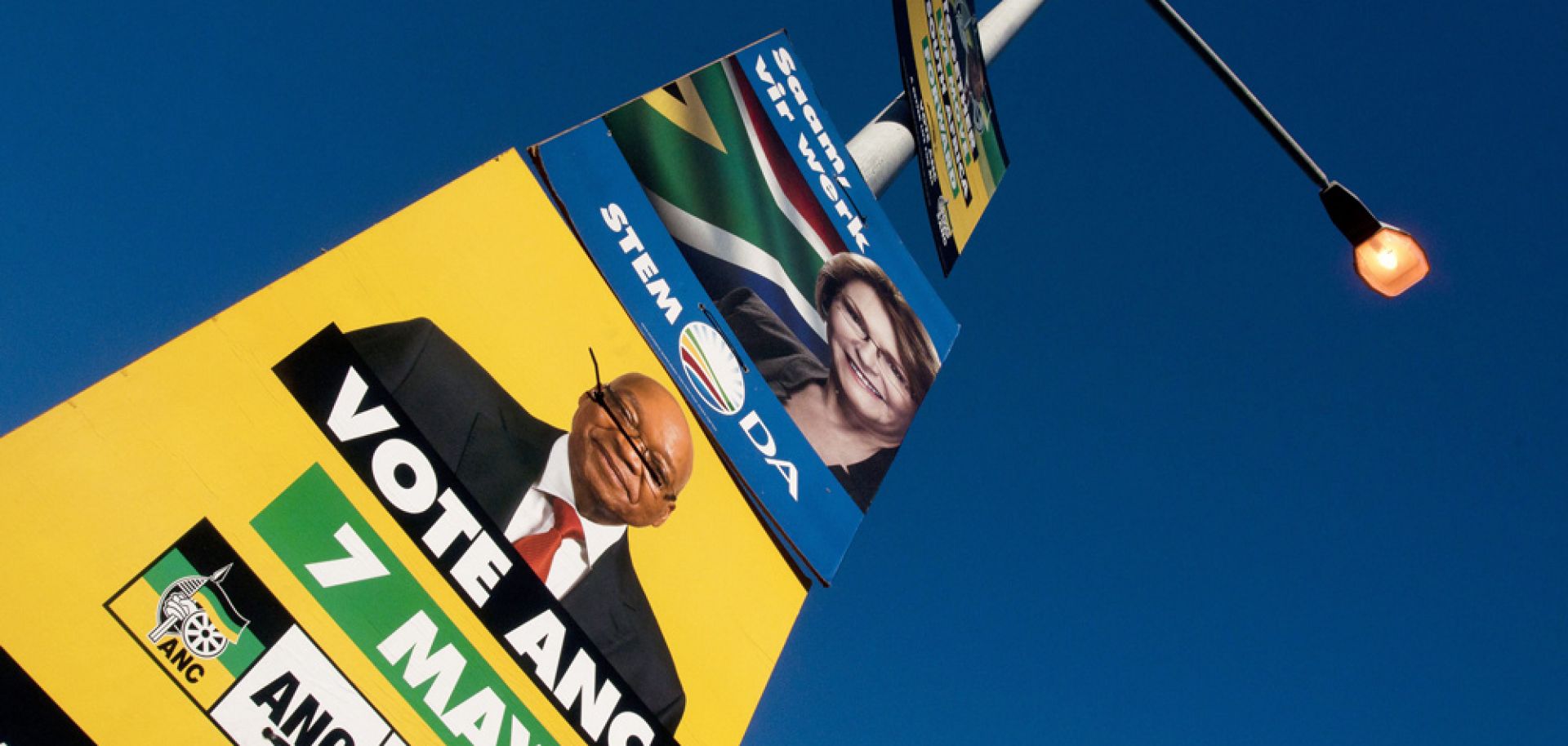 Election posters with the faces of Jacob Zuma (in yellow), African National Congress and South African president, and Helen Zille (in blue), opposition Democratic Alliance are displayed on May 2.