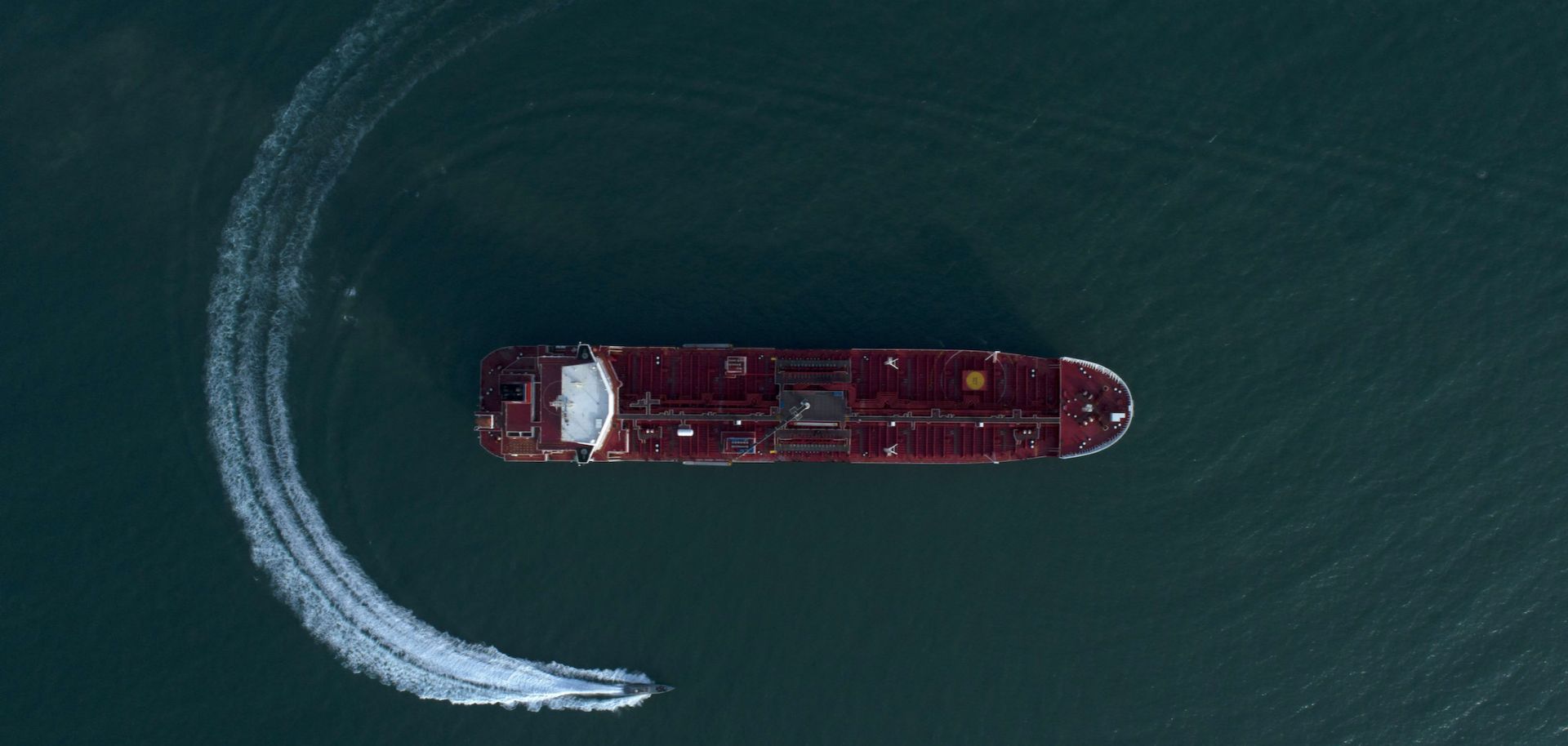 A boat circles the U.K.-flagged Stena Impero tanker in July 2019 after it was seized and detained by Iranian forces in the Strait of Hormuz. 