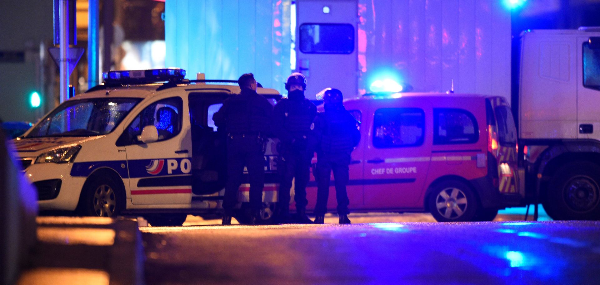 Police officers stand in the Neudorf area of Strasbourg, eastern France, after a shooting.