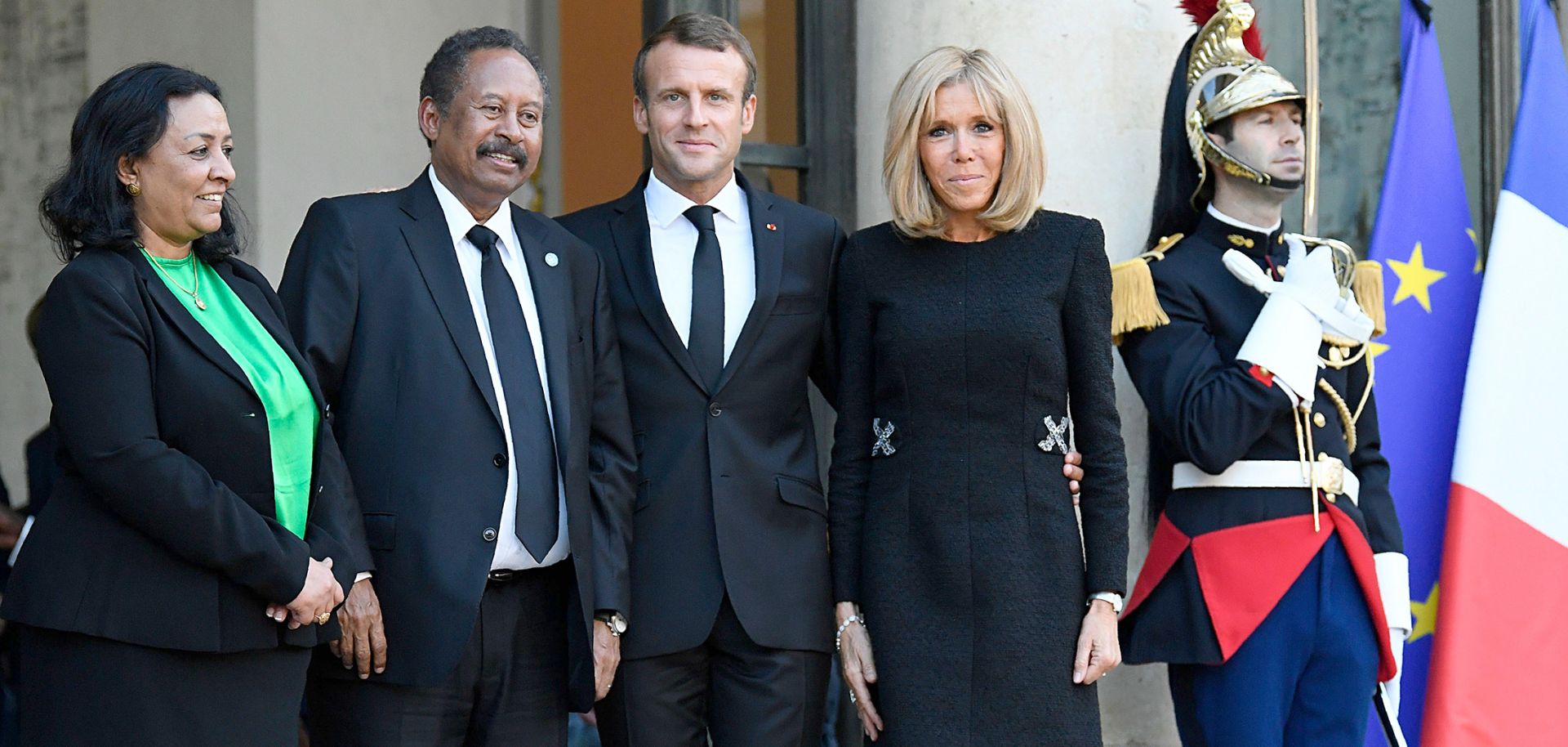 Sudanese Prime Minister Abdalla Hamdok (2L) is joined by his wife (L), economist Muna Abdalla, and French President Emmanuel Macron (C) and his spouse, Brigitte Macron (2R) in Paris on Sept. 30, 2019.