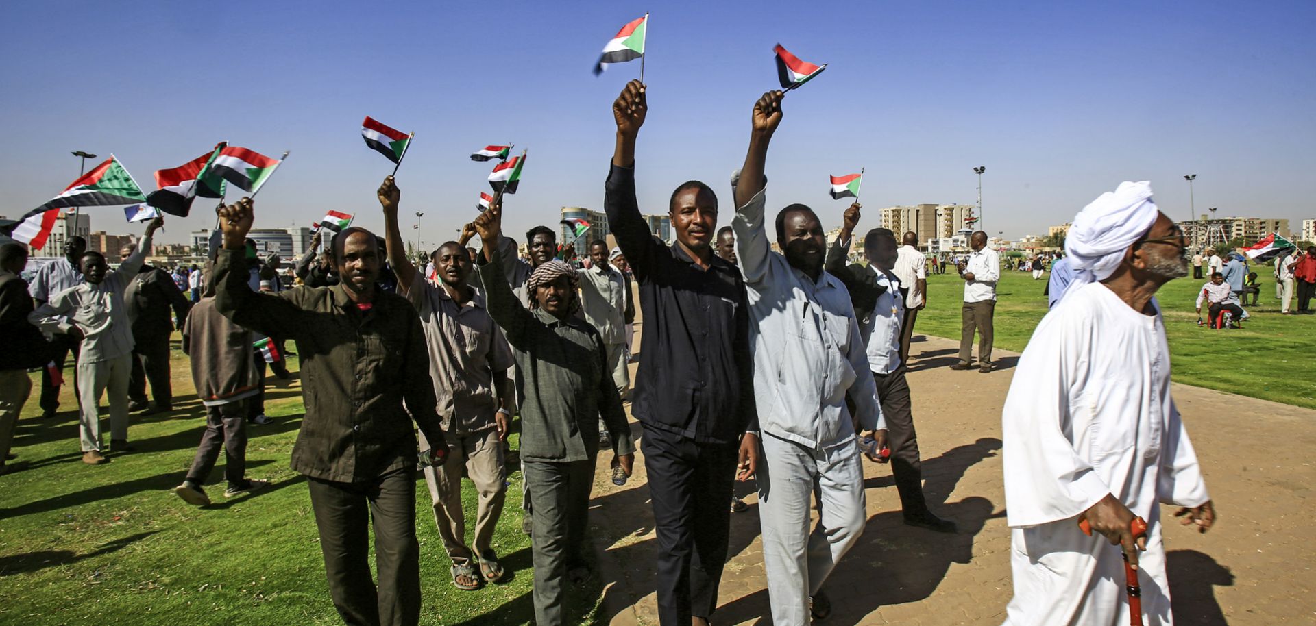 Supporters of President Omar al Bashir wave Sudanese flags during a rally for him at the Green Square in the capital Khartoum on Jan. 9, 2019.