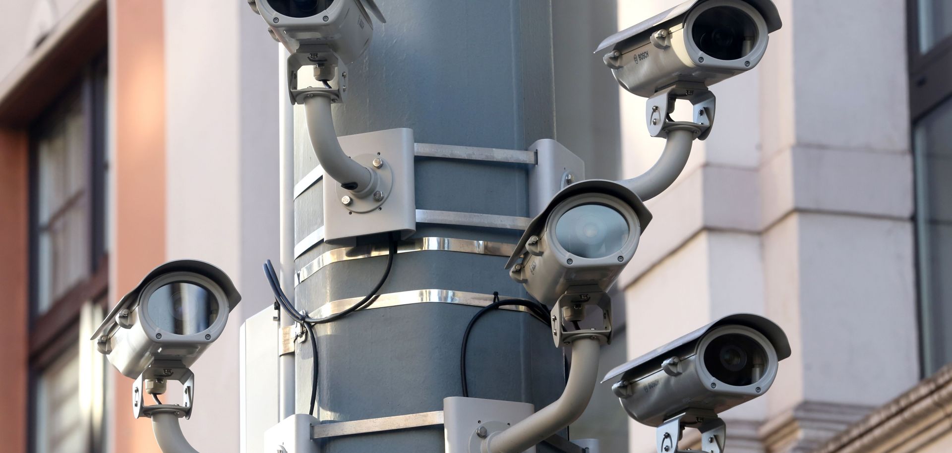 Five surveillance cameras on a lamppost. 