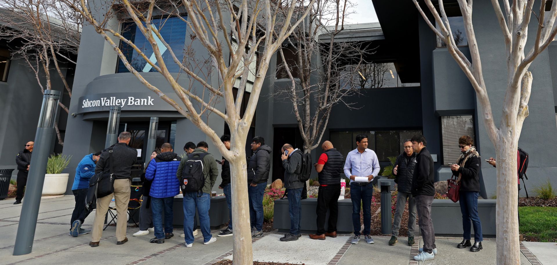 People seeking to retrieve their funds from the failed Silicon Valley Bank line up outside of the bank's offices in Santa Clara, California, on March 13, 2023.