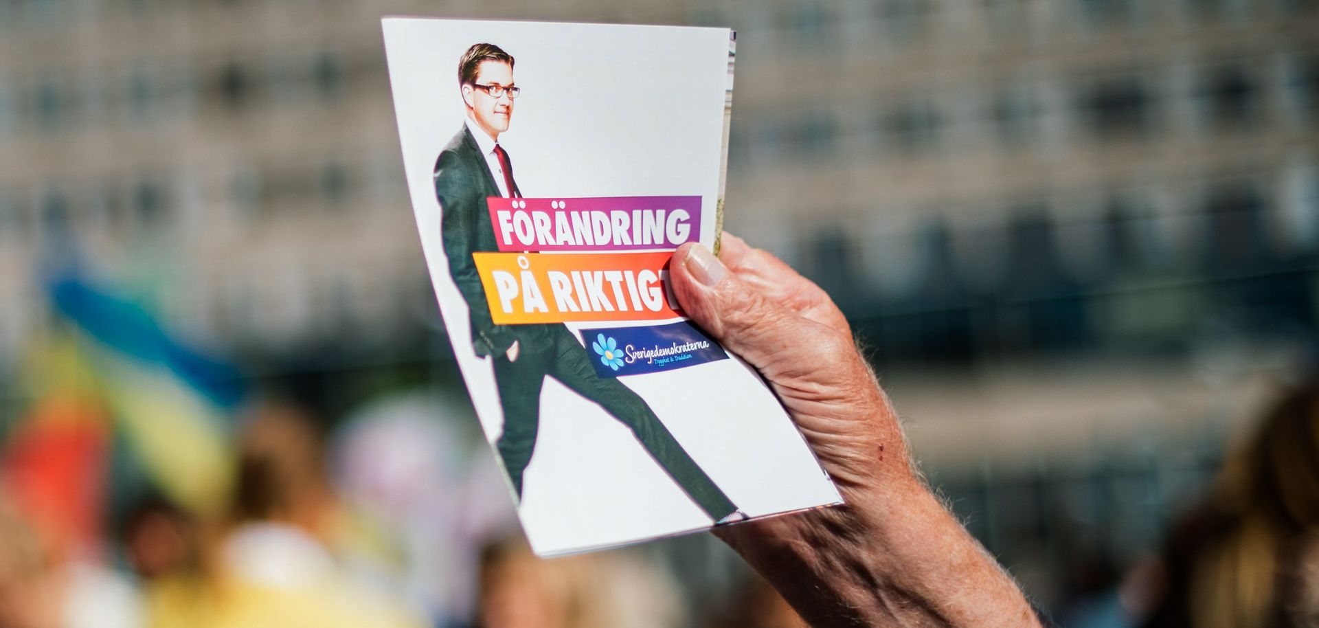 A volunteer hands out leaflets supporting Swedish Democrats leader Jimmie Akesson on Sept. 10, 2014, in Stockholm.