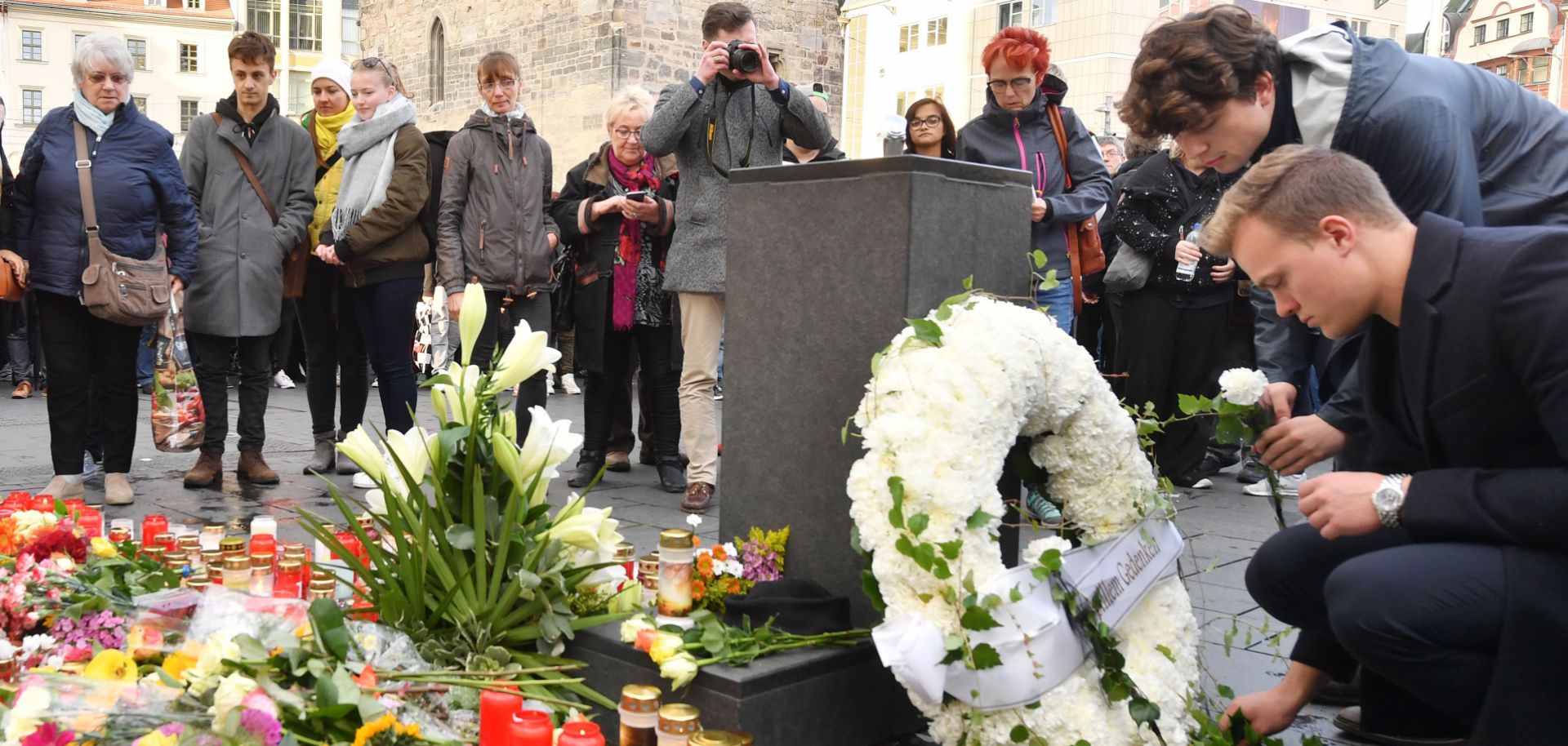 Mourners place flowers at a makeshift memorial on Oct. 10, 2019, at the market square in Halle, Germany, one day after a deadly anti-Semitic shooting.