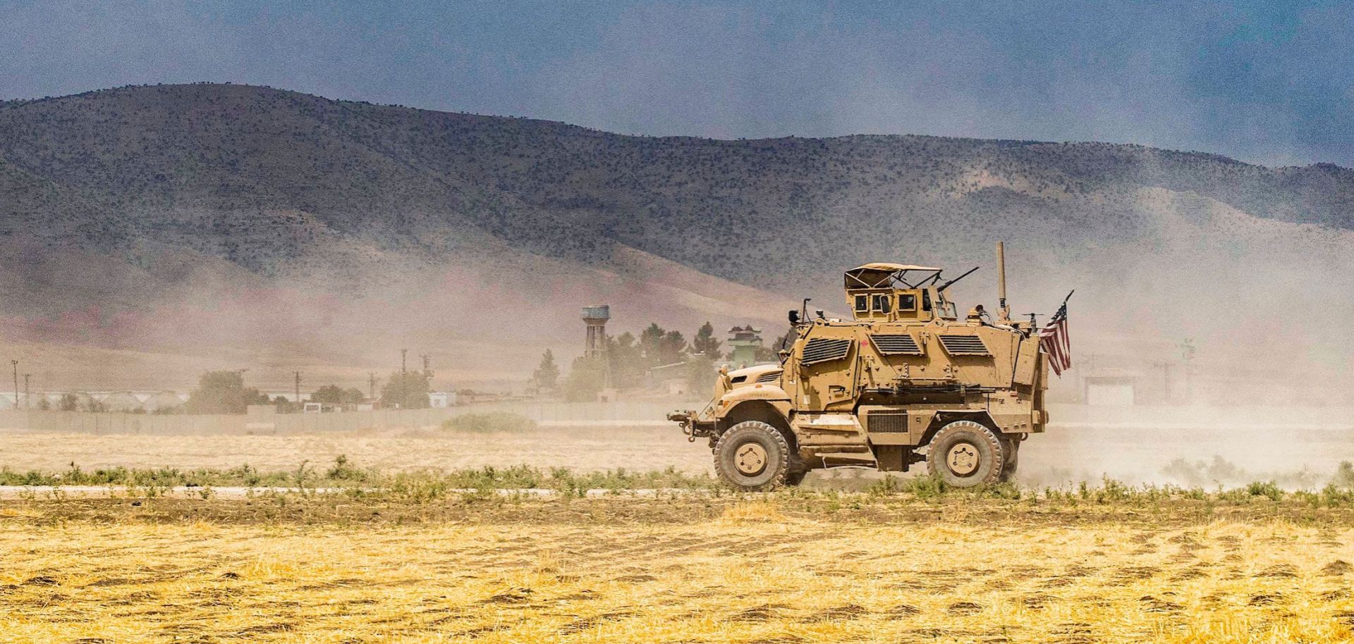 A U.S. Oshkosh M-ATV Mine Resistant Ambush Protected military vehicle patrols near the Syria-Turkey border in a village east of Qamishli in Syria's northeastern Hasakah province on Aug. 21. The village was subject to bombardment the previous week.