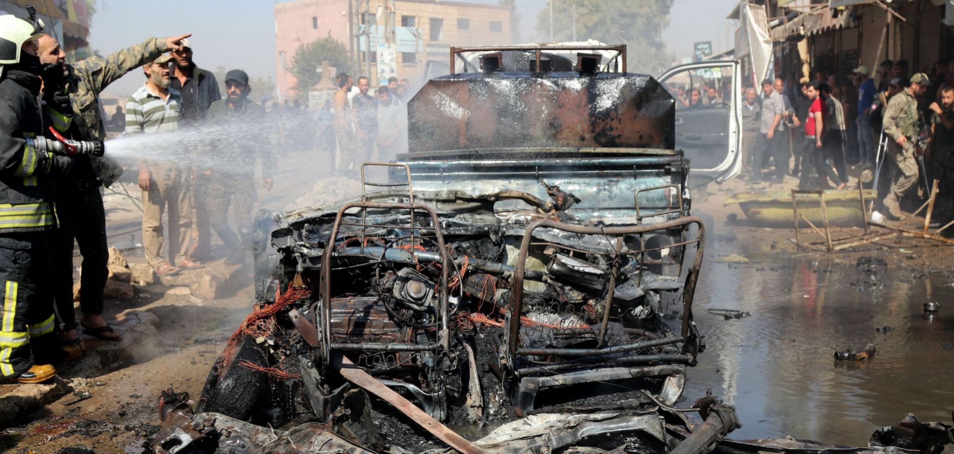 A vehicle destroyed in a bombing is seen in Syria's rebel-held northern city of Afrin on Oct. 11, 2021. 