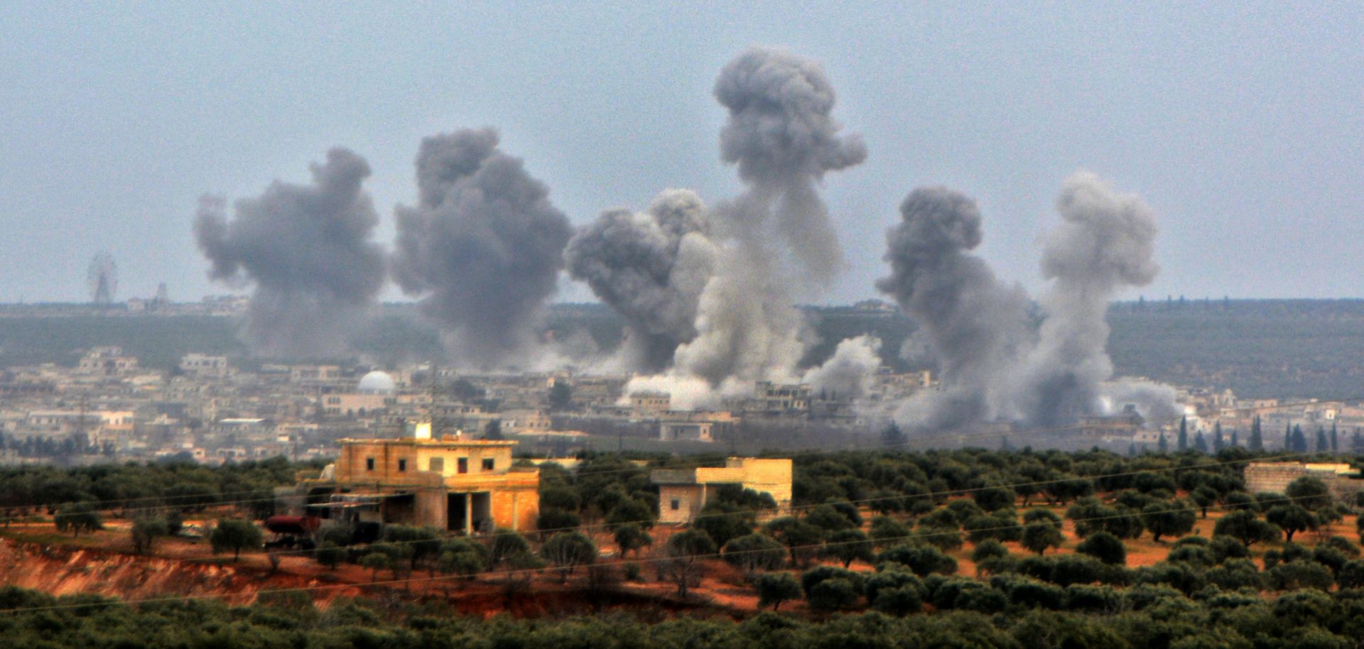 Smoke from a reported Syrian government airstrike billows over Qaminas, Syria, about 4 miles southeast of Idlib city on Feb. 24, 2020.