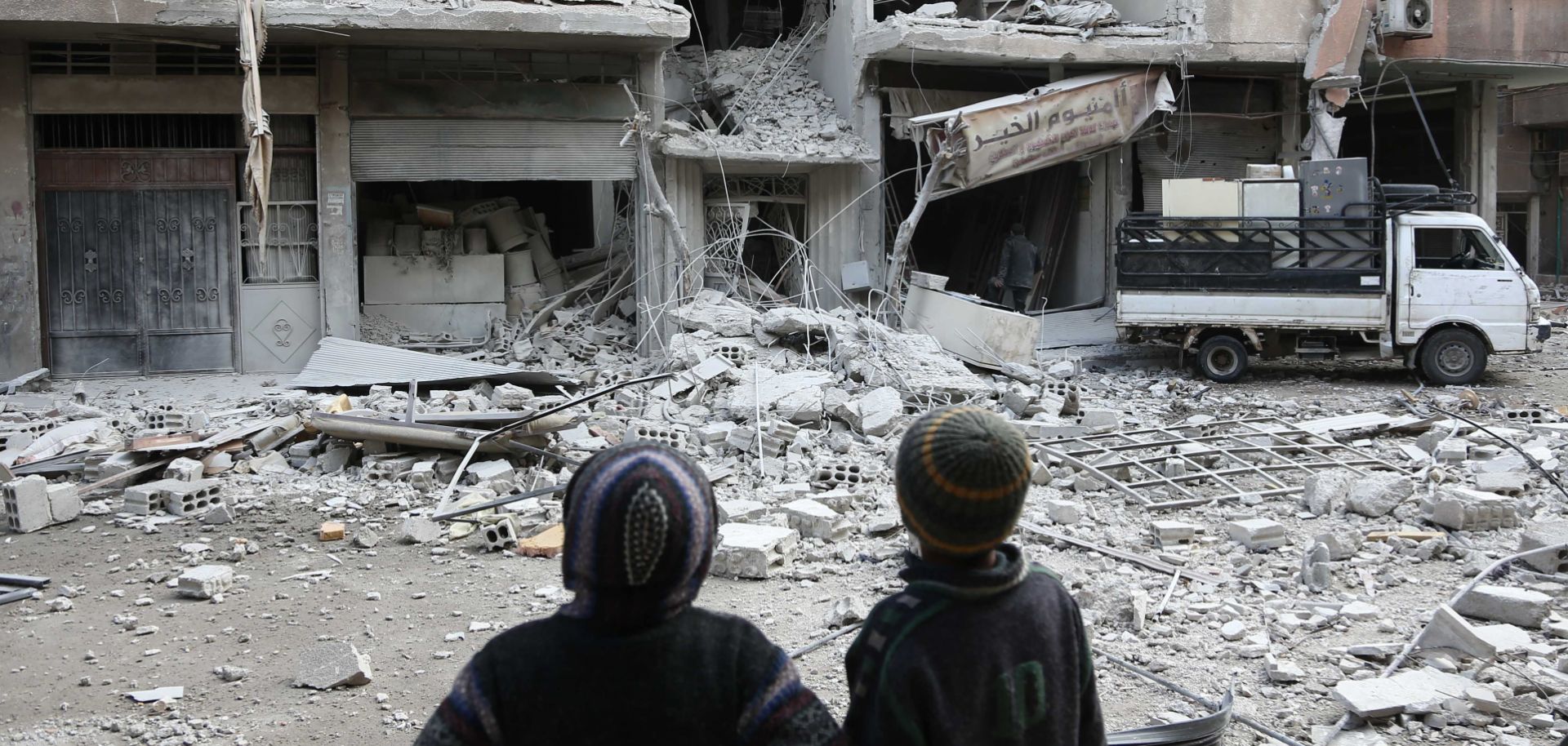 Children survey the damage to a building just outside Damascus that sustained a missile attack from forces loyal to the Syrian government Jan. 18.