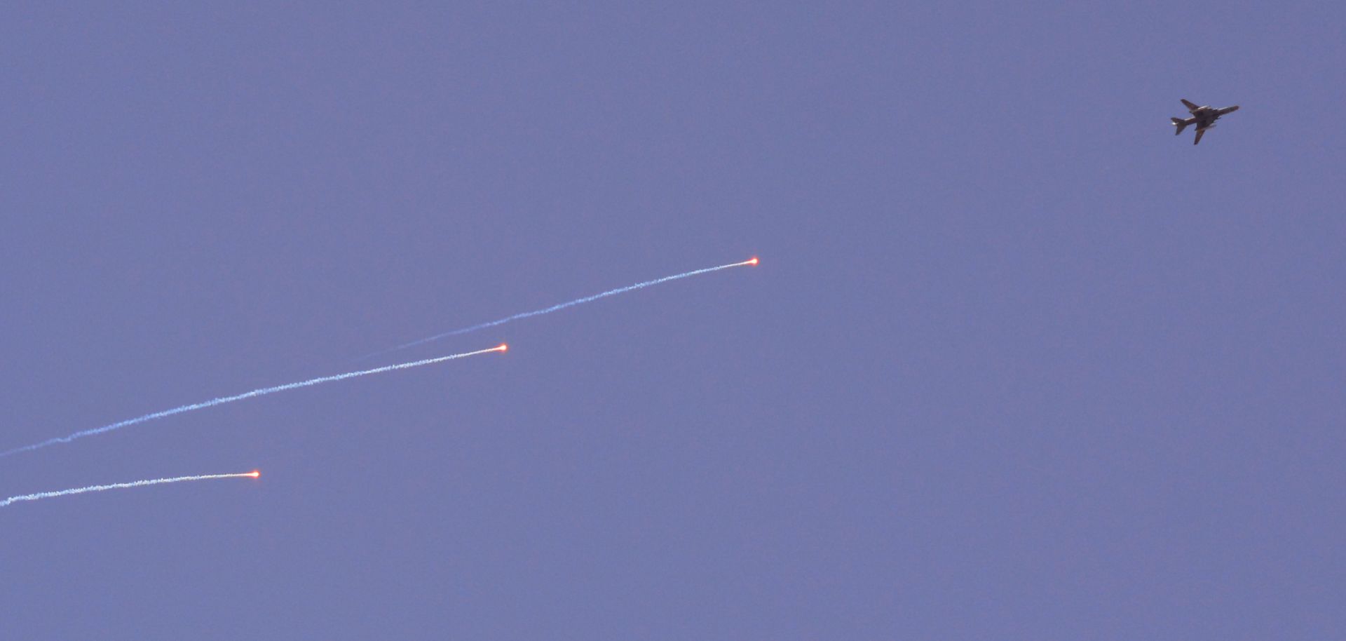 A Syrian air force Sukhoi Su-22 fighter jet flies over the Palestinian camp of Yarmuk on the southern outskirts of Damascus during airstrikes on the Islamic State in April 2018.