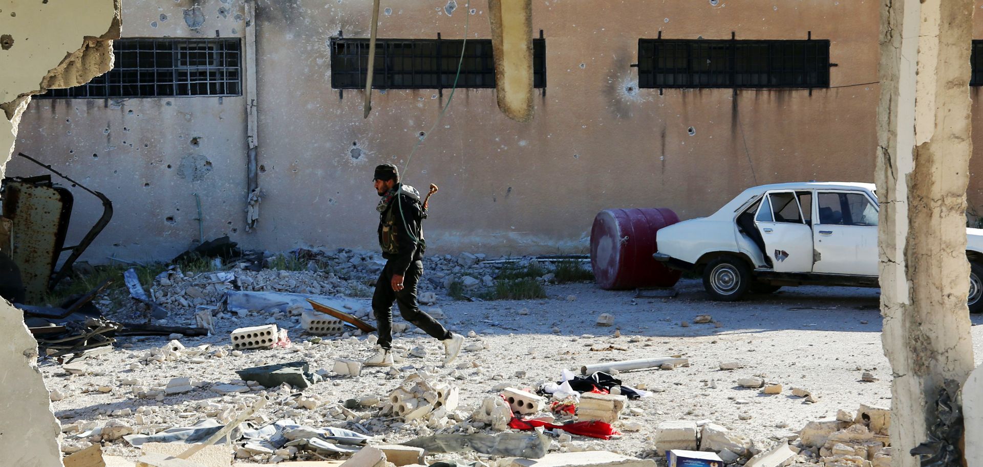 A Kurdish fighter inspects a prison in the northeastern Syrian city of Qamishli on April 22. The Kurds are playing a central role in the Syrian conflict as Russia, the United States and Turkey try to use the minority group to meet their own goals.