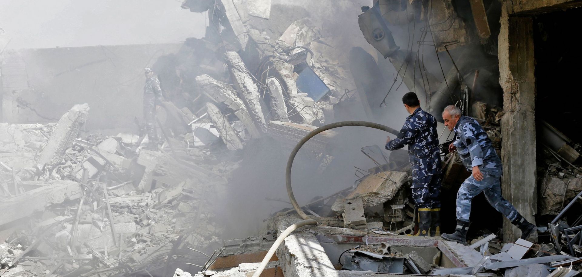Syrian soldiers inspect the wreckage of a building on April 14, 2018, after the United States, Britain and France launched strikes against Syrian government targets in response to an alleged chemical weapons attack.