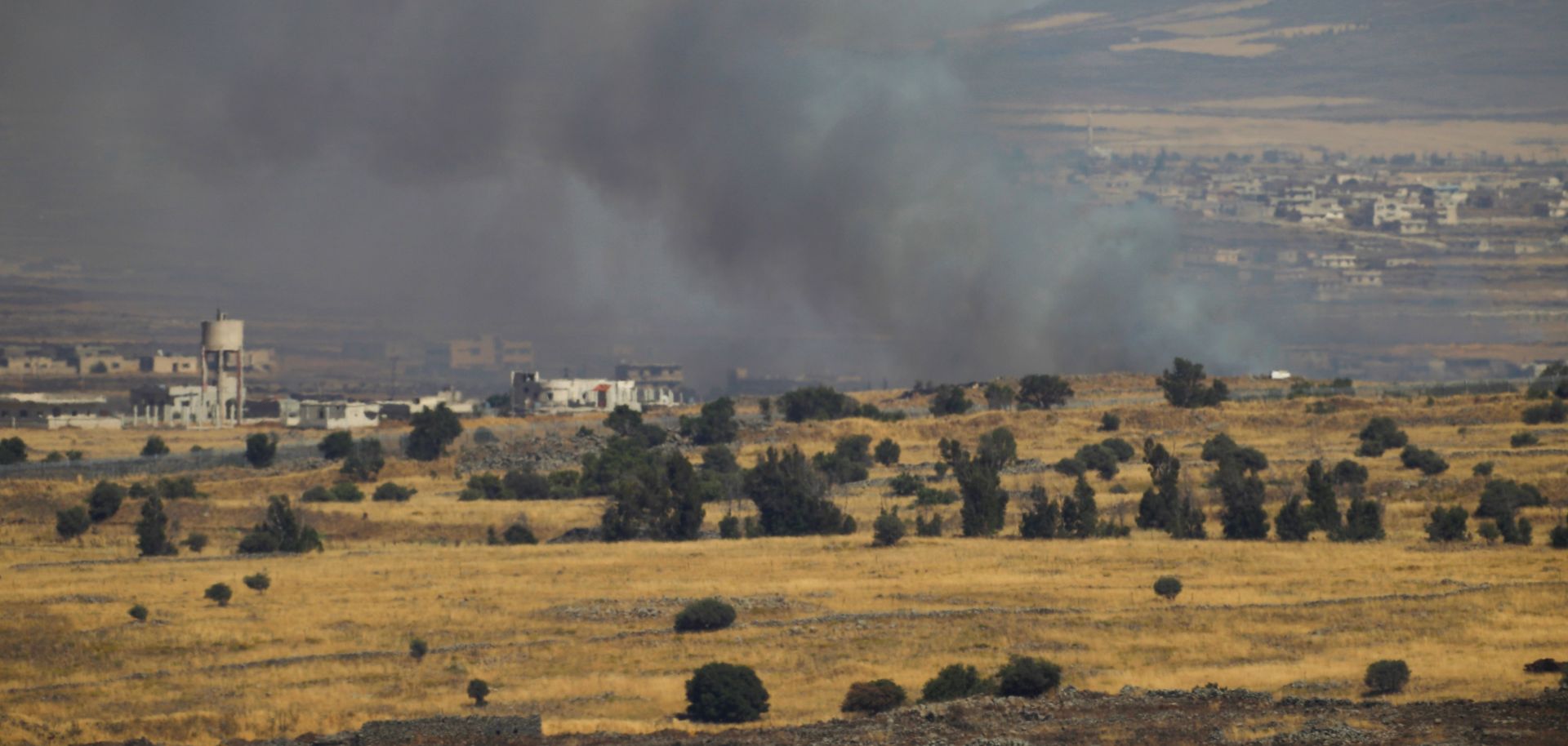 A column of smoke rises from Syria, near its border with the Israeli-occupied Golan Heights, on June 24, 2017, after an Israeli airstrike.