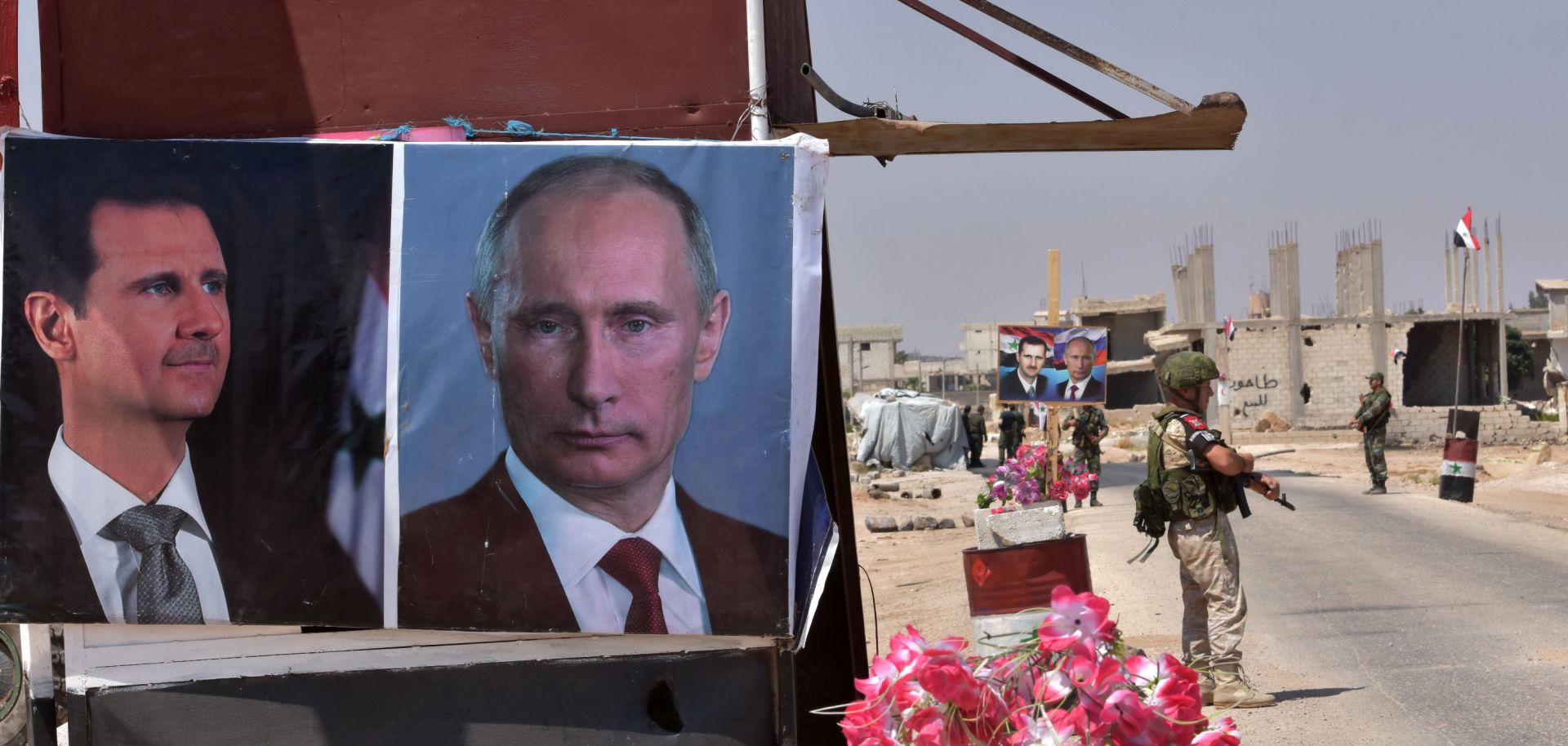 Posters of Syrian President Bashar al Assad and of Russian President Vladimir Putin adorn a kiosk at a border crossing in eastern Idlib province.
