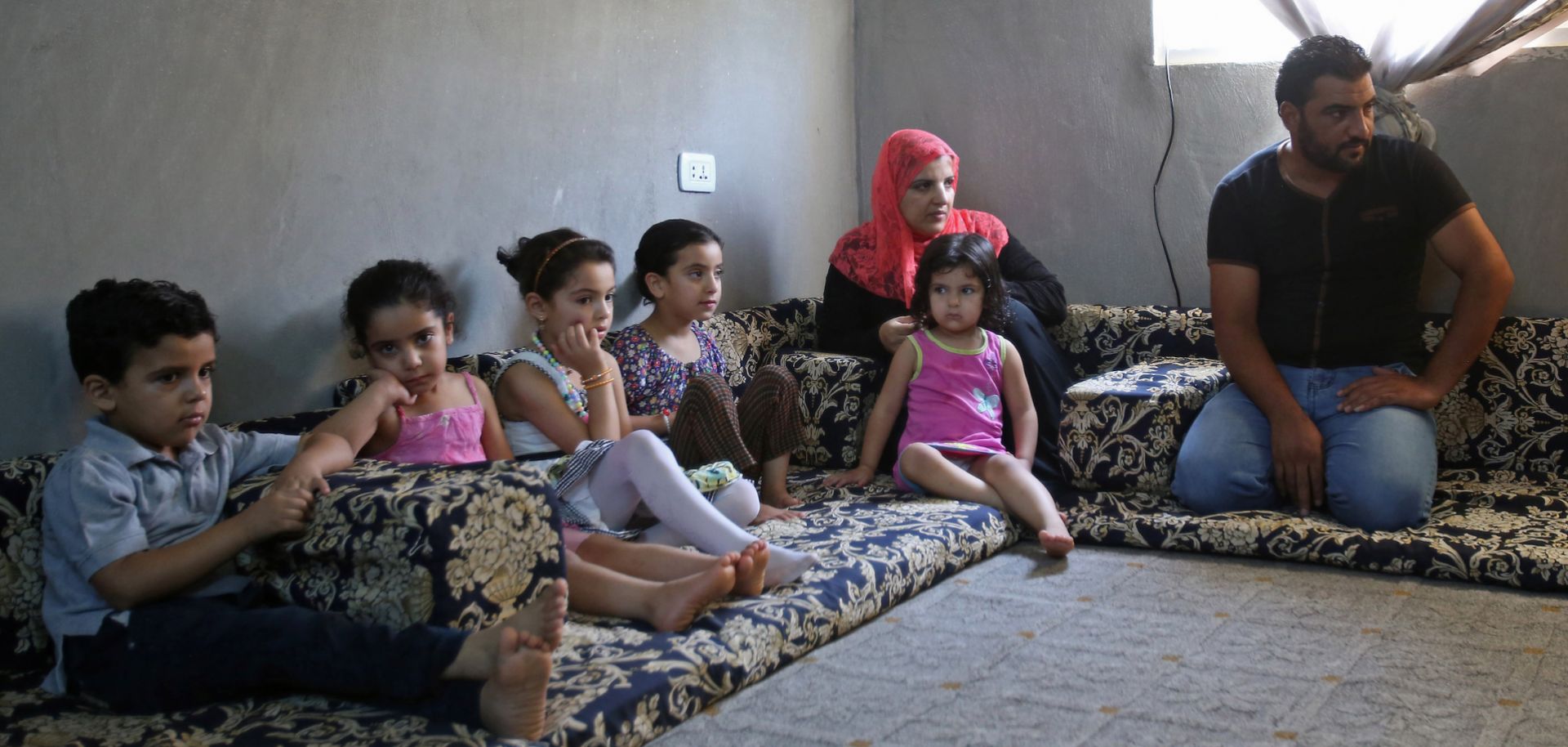 A Syrian refugee family sit in a home in Jordan where a Norwegian nongovernmental organization has arranged for them to stay.
