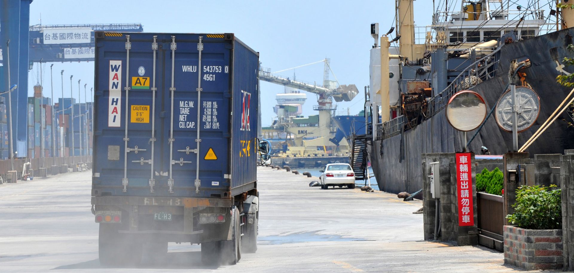 A container truck drives along a pier at Taiwan's busy northern Keelung harbor.