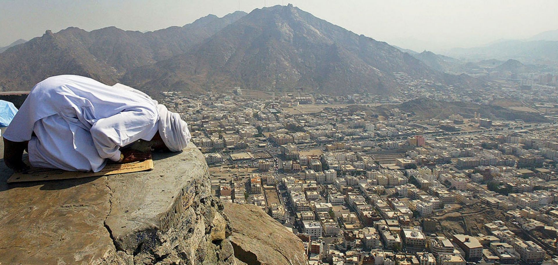 A hajj pilgrim prays near Hira cave, where Muslims believe God revealed the first verses of the Koran to the Prophet Muhammad.