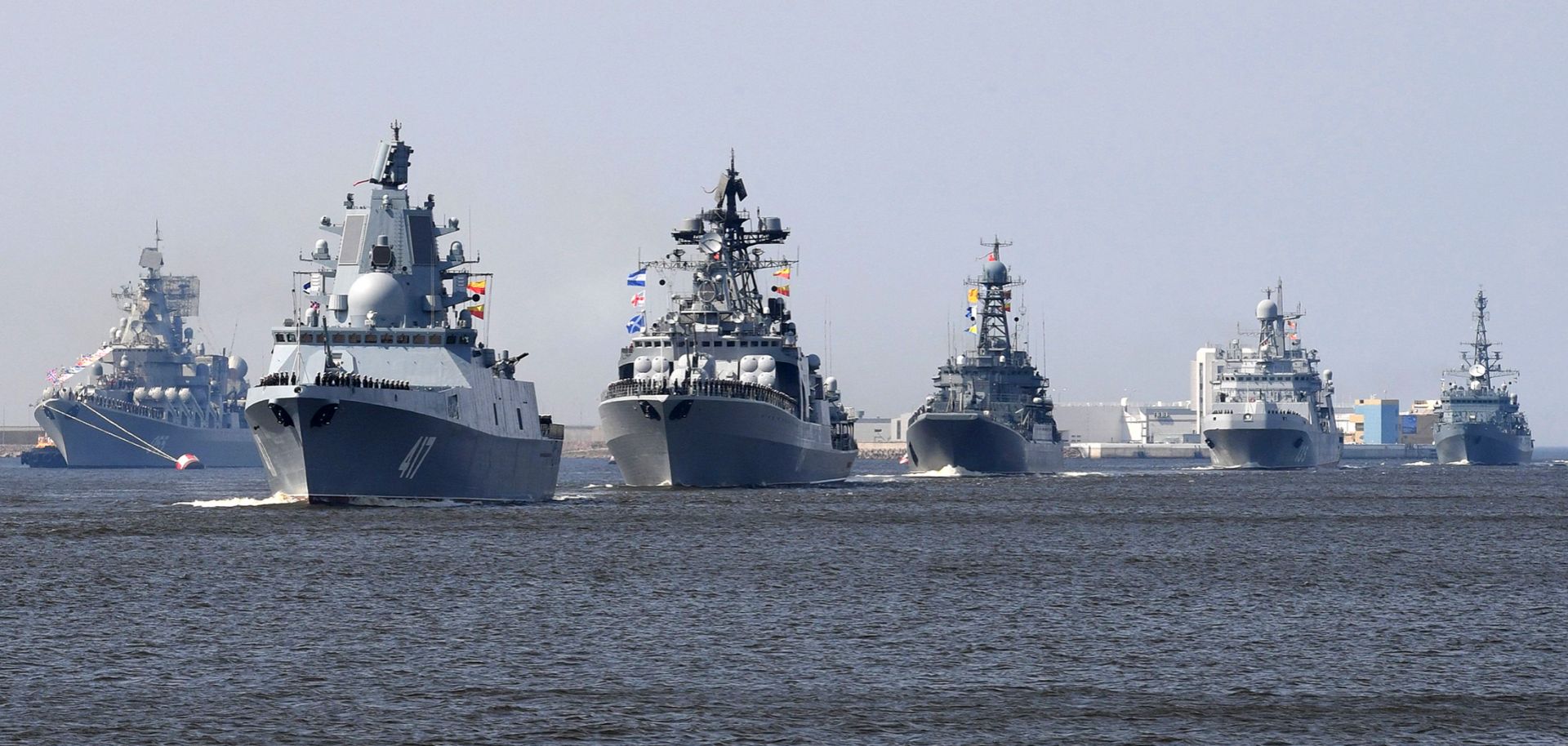 Russian navy ships, among them the Russian frigate Admiral Gorshkov, second from left, sail near Kronshtadt naval base outside St. Petersburg on July 20, 2018.