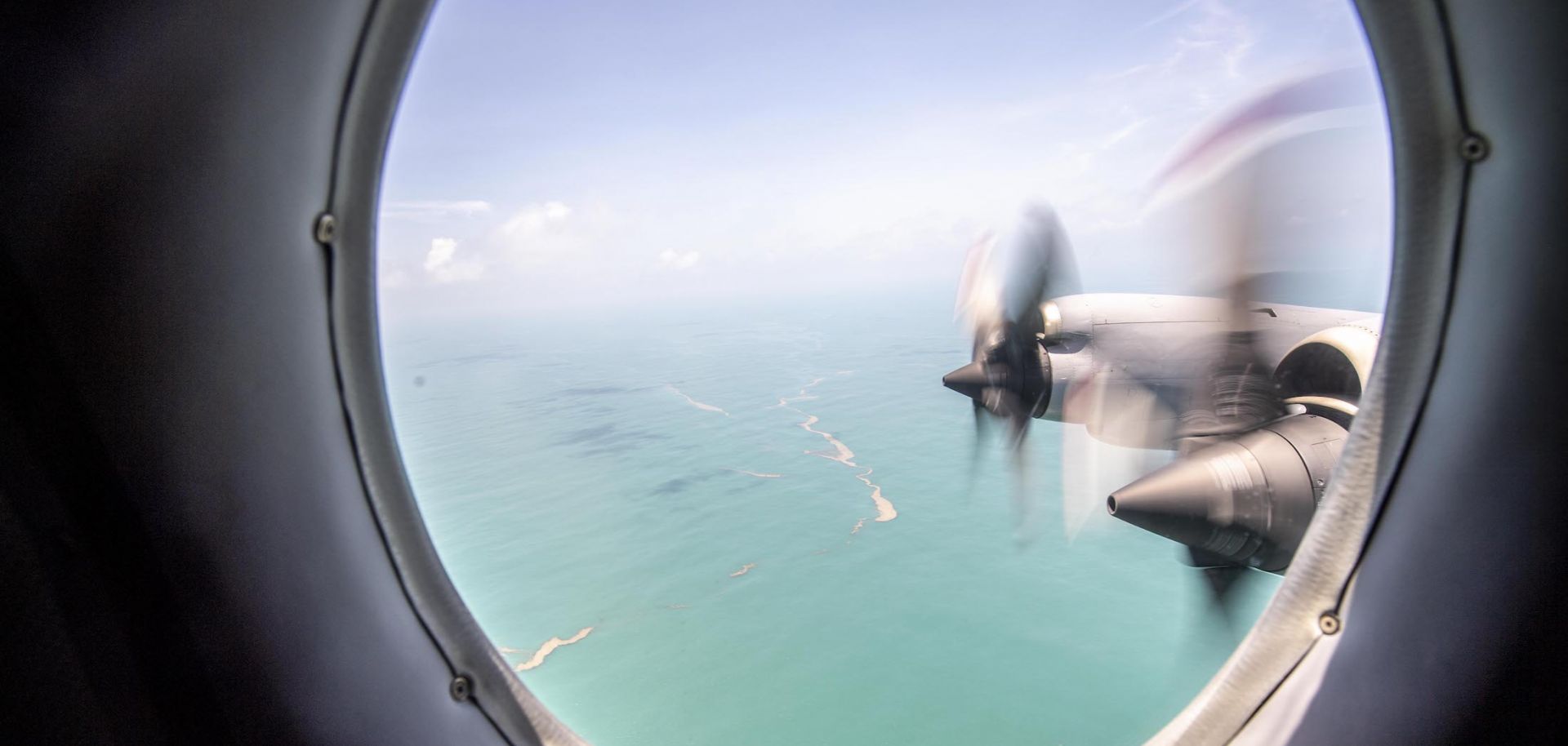 A P-3K2 Orion aircraft flying over Tonga's Nomuka island shows heavy ash fall from the recent volcanic eruption within the Tongan Islands on Jan. 17.