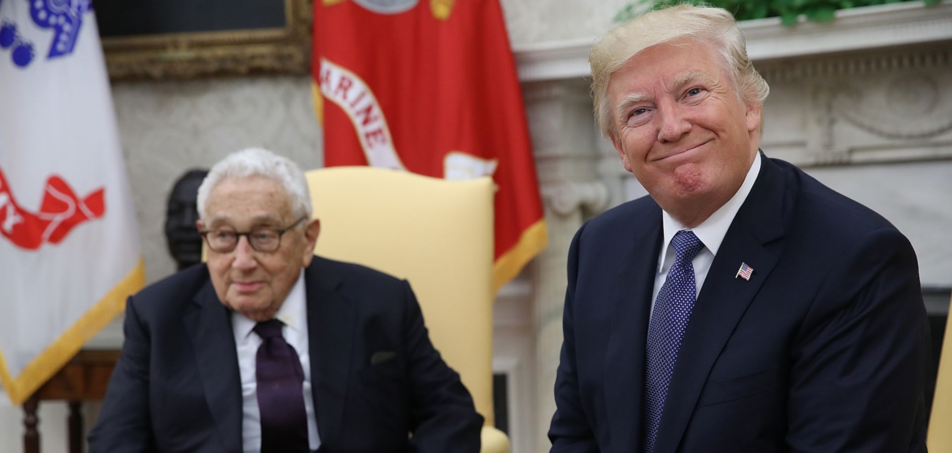 U.S. President Donald Trump (R) meets with former U.S. Secretary of State Henry Kissinger in the Oval Office in October 2017 in Washington.
