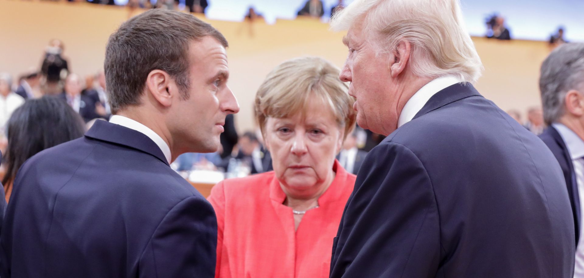 German Chancellor Angela Merkel talks with U.S. President Donald Trump and French President Emmanuel Macron at a G-20 meeting in Hamburg, Germany, in July 2017.