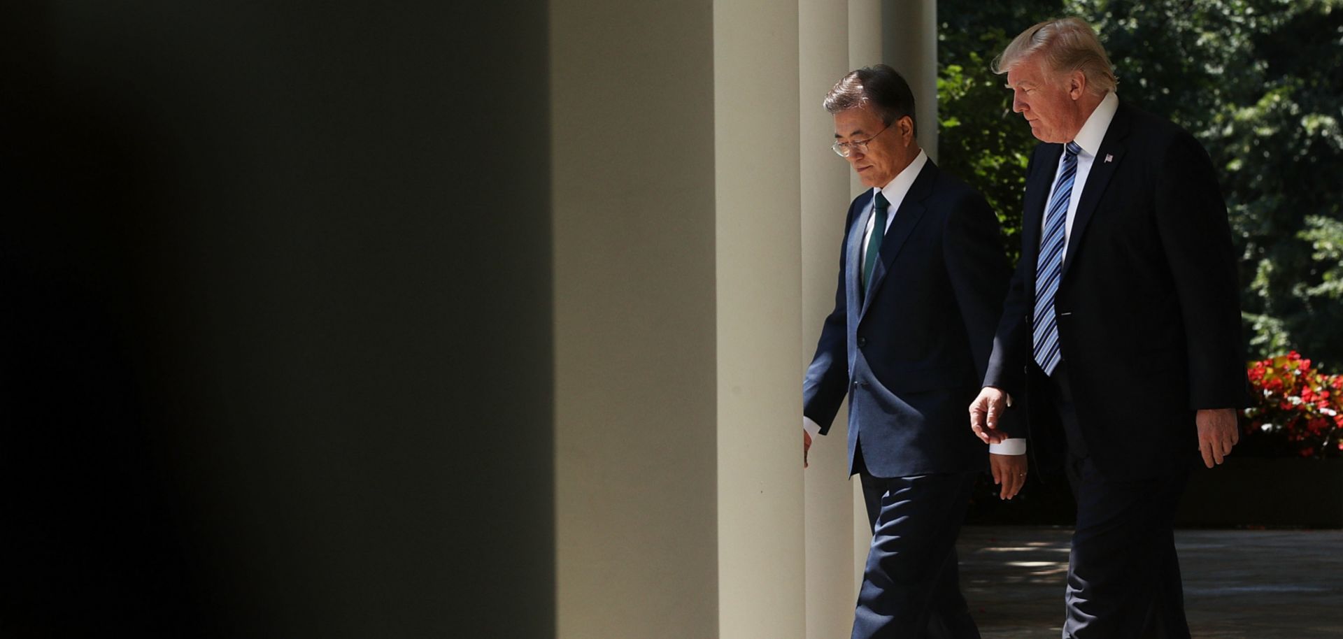 South Korean President Moon Jae In walks beside U.S. President Donald Trump at the White House in June 2017.