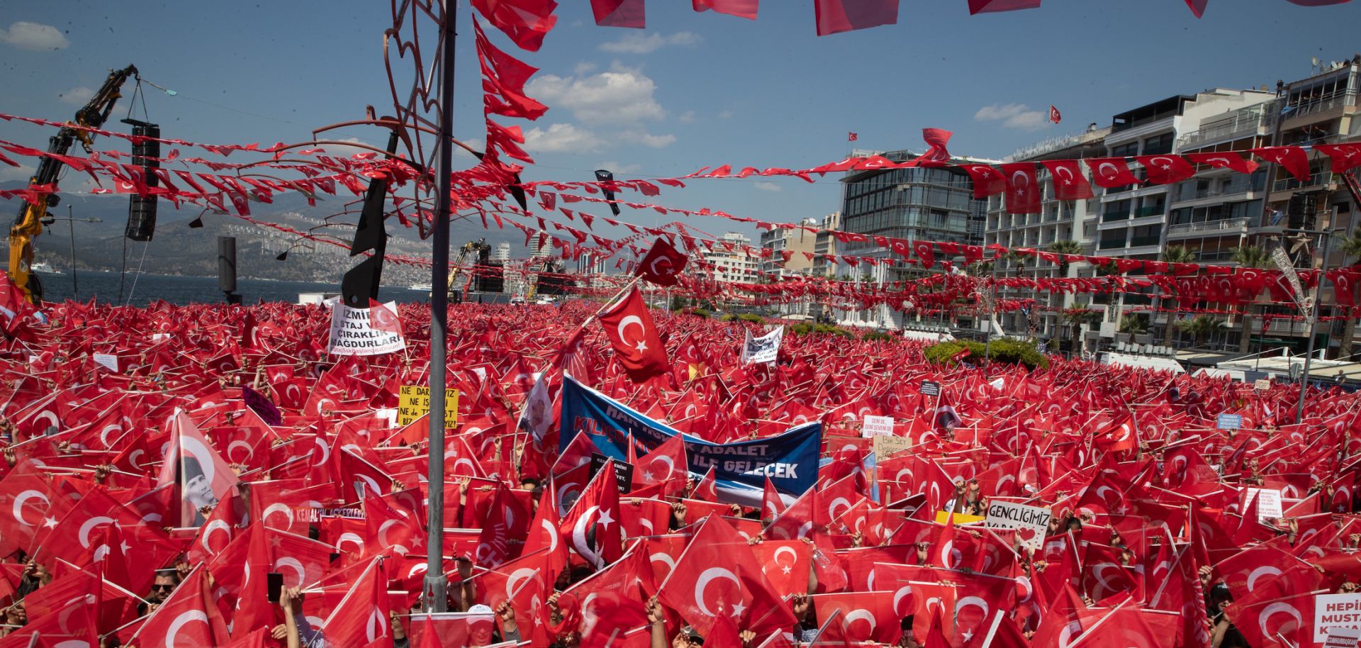 Opposition supporters wave Turkish flags and chant slogans while waiting for the arrival of their presidential candidate Kemal Kilicdaroglu during a campaign rally in Izmir, Turkey, on April 30, 2023.