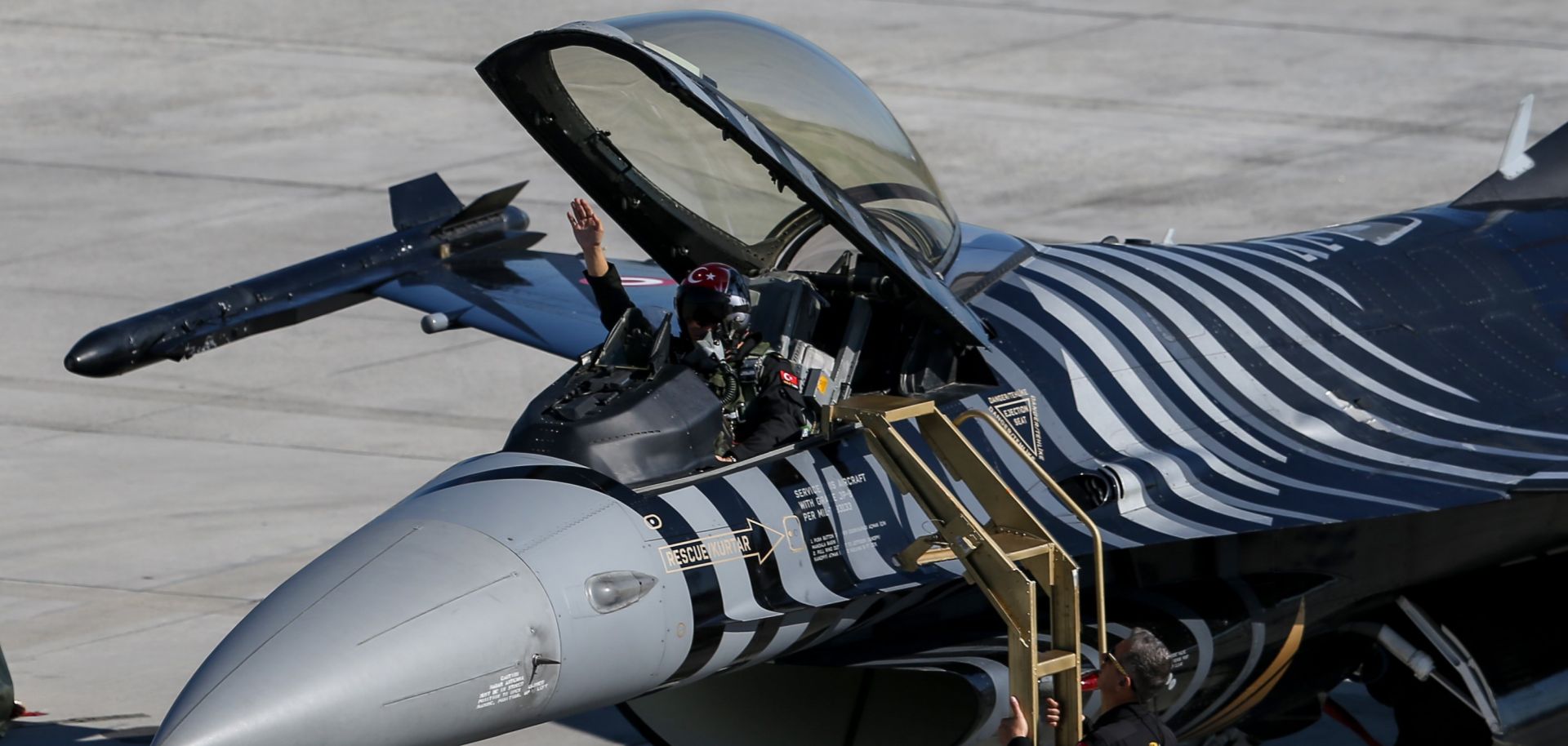 The pilot of a Turkish F-16 greets the crowd after performing at the Teknofest Istanbul Aerospace and Technology Festival in Istanbul on Sept. 22, 2019. 